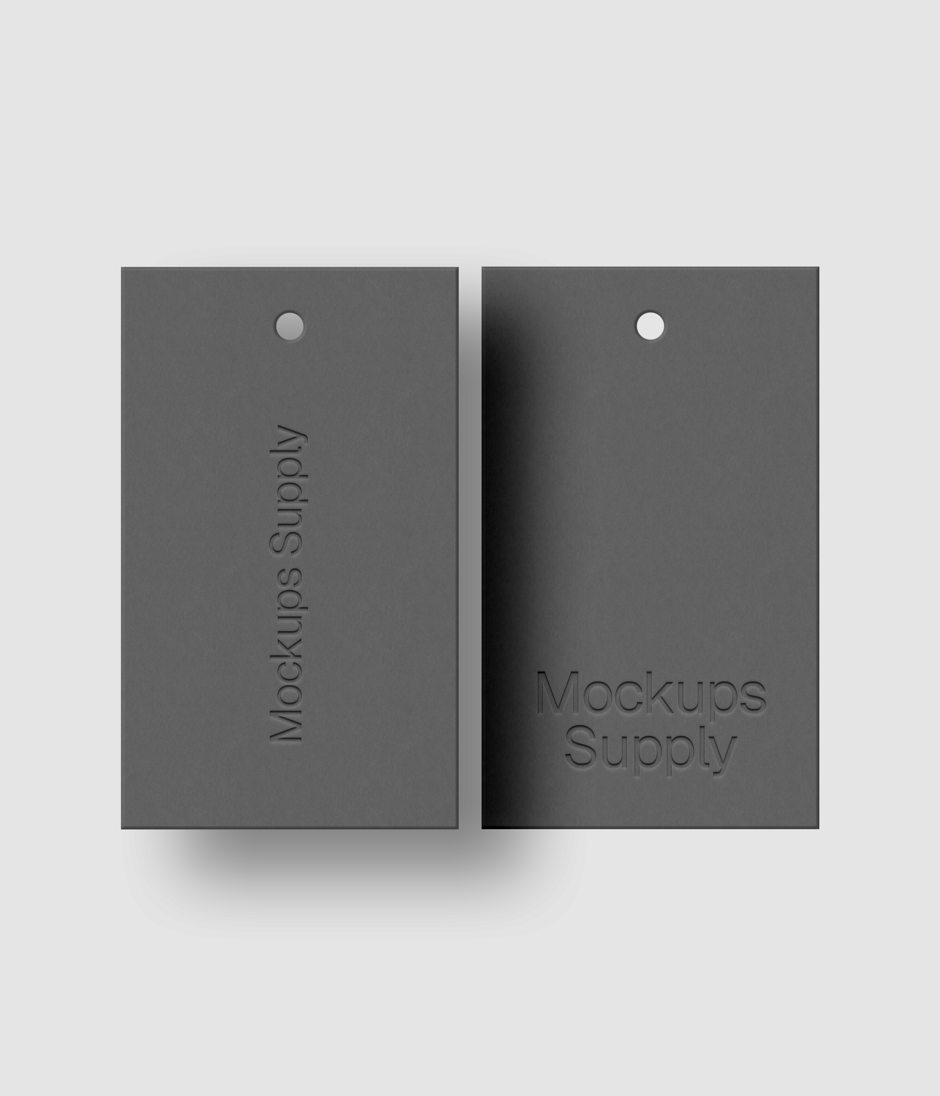Two gray 3x5 hang tags mockup on white background with natural shadow depth and debossed logo effect for Photoshop download psd
