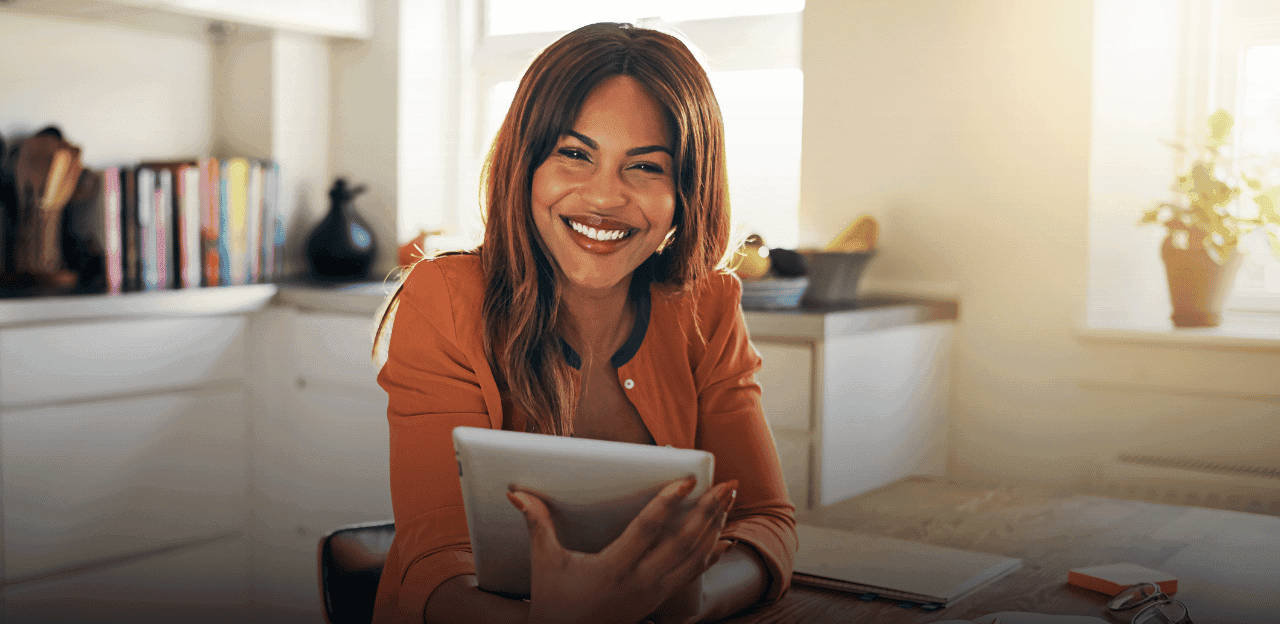 A smiling young woman in a warm, inviting office setting