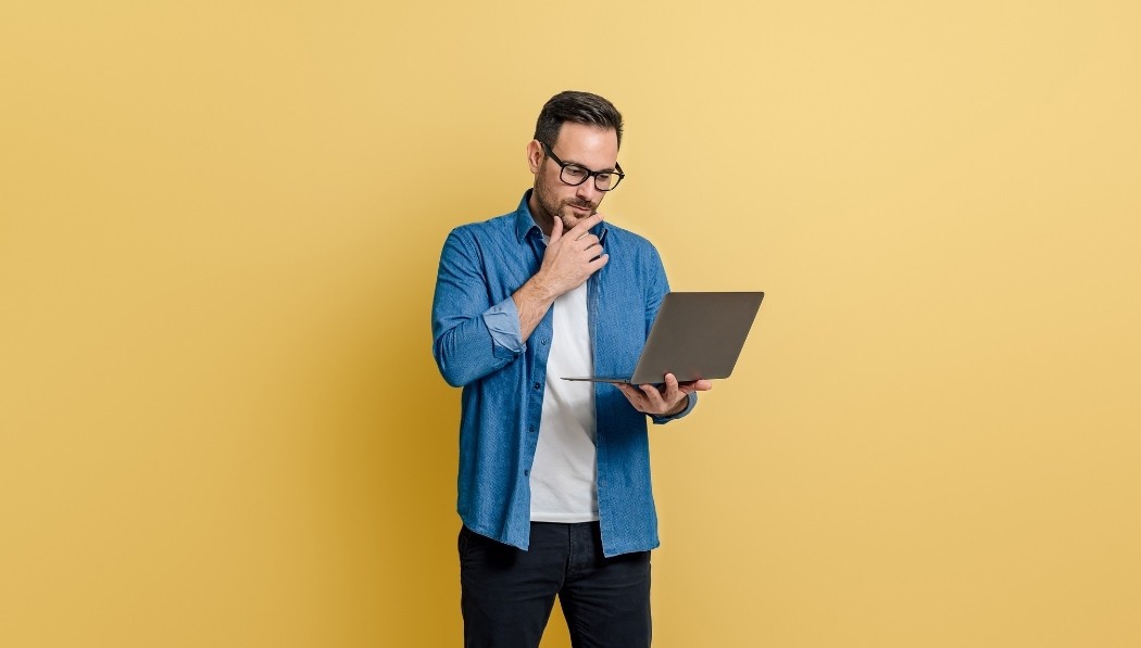 Man thinking whilst looking at the computer