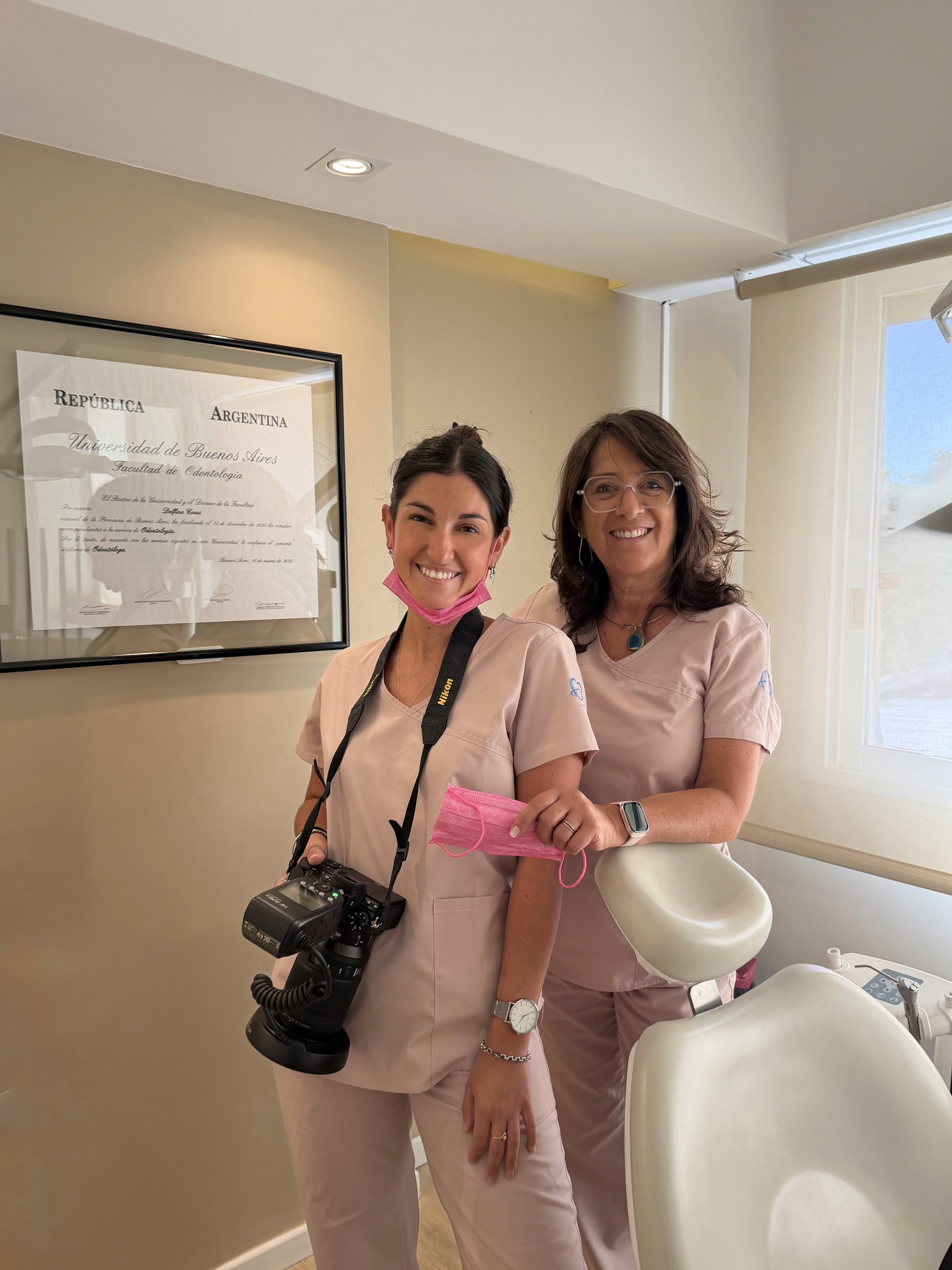 Dental team smiling with a patient in a clinic setting