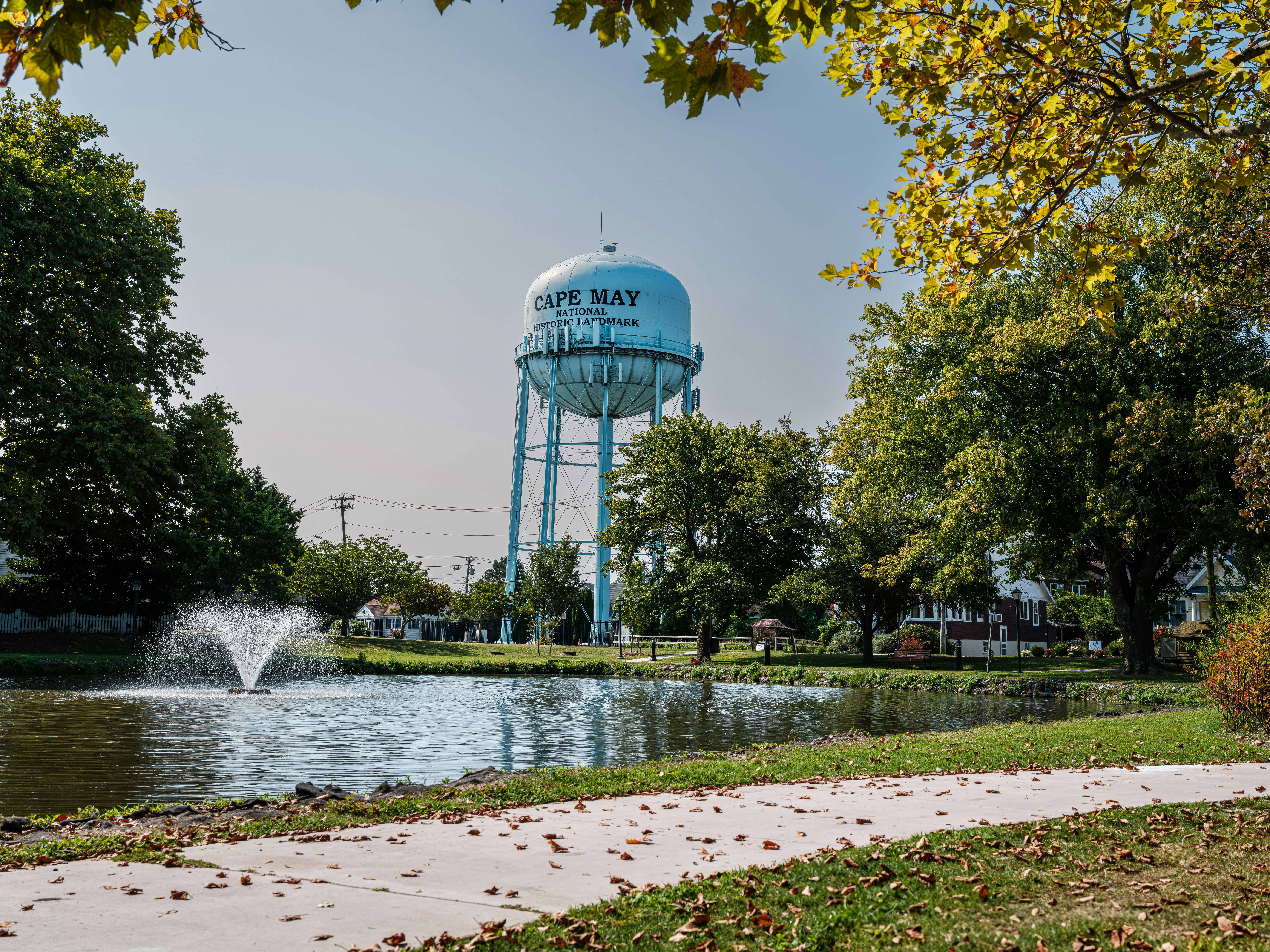 A water tower in the distance with a fountain in the foreground
