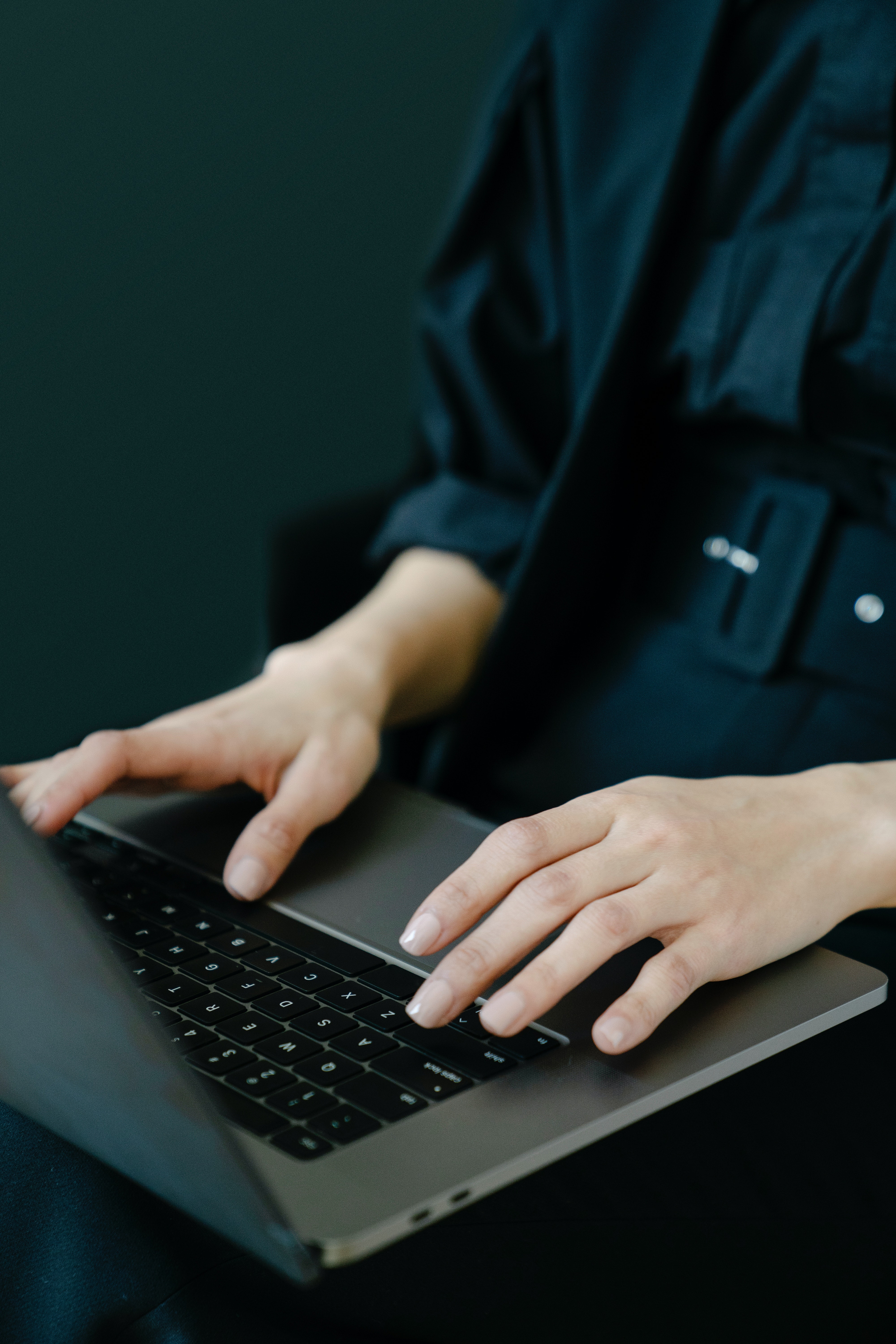 A woman is working on a laptop