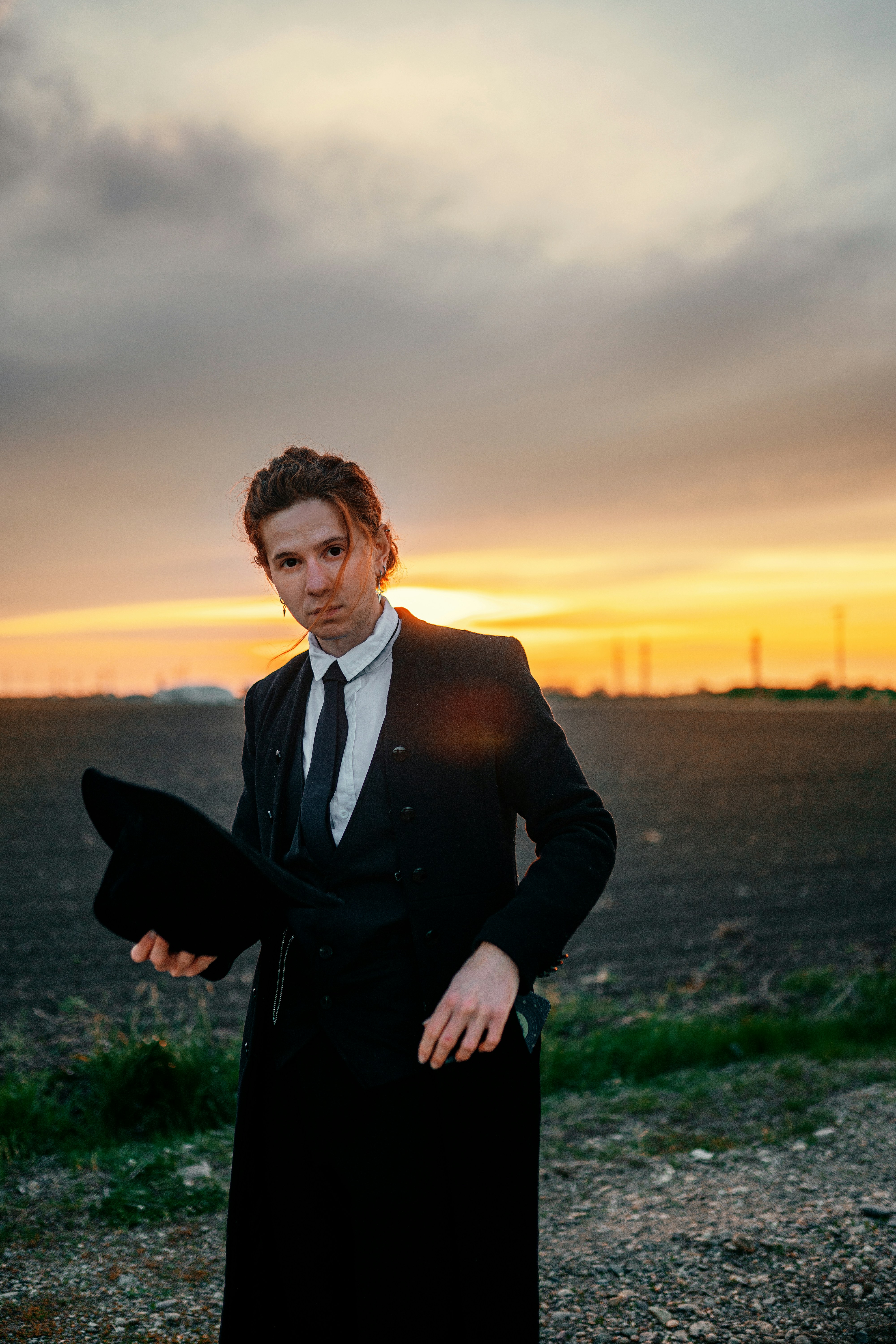 A man in a suit and tie standing in a field