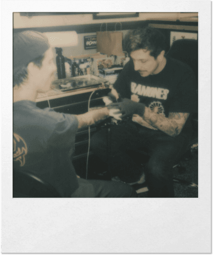 polaroid photo of Danny Piedra applying a tattoo