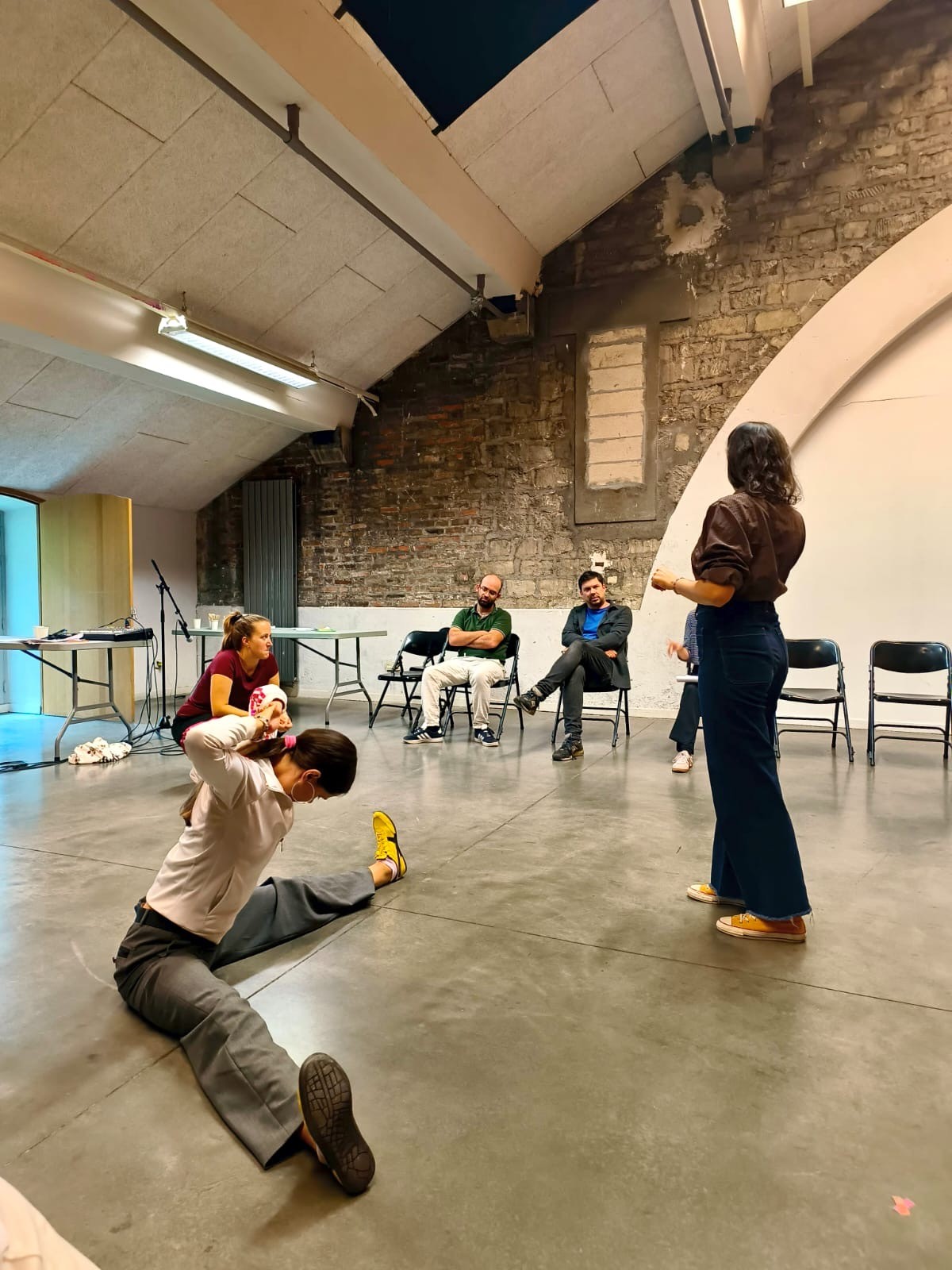 Woman in pink leather jacket crouching outdoors at night