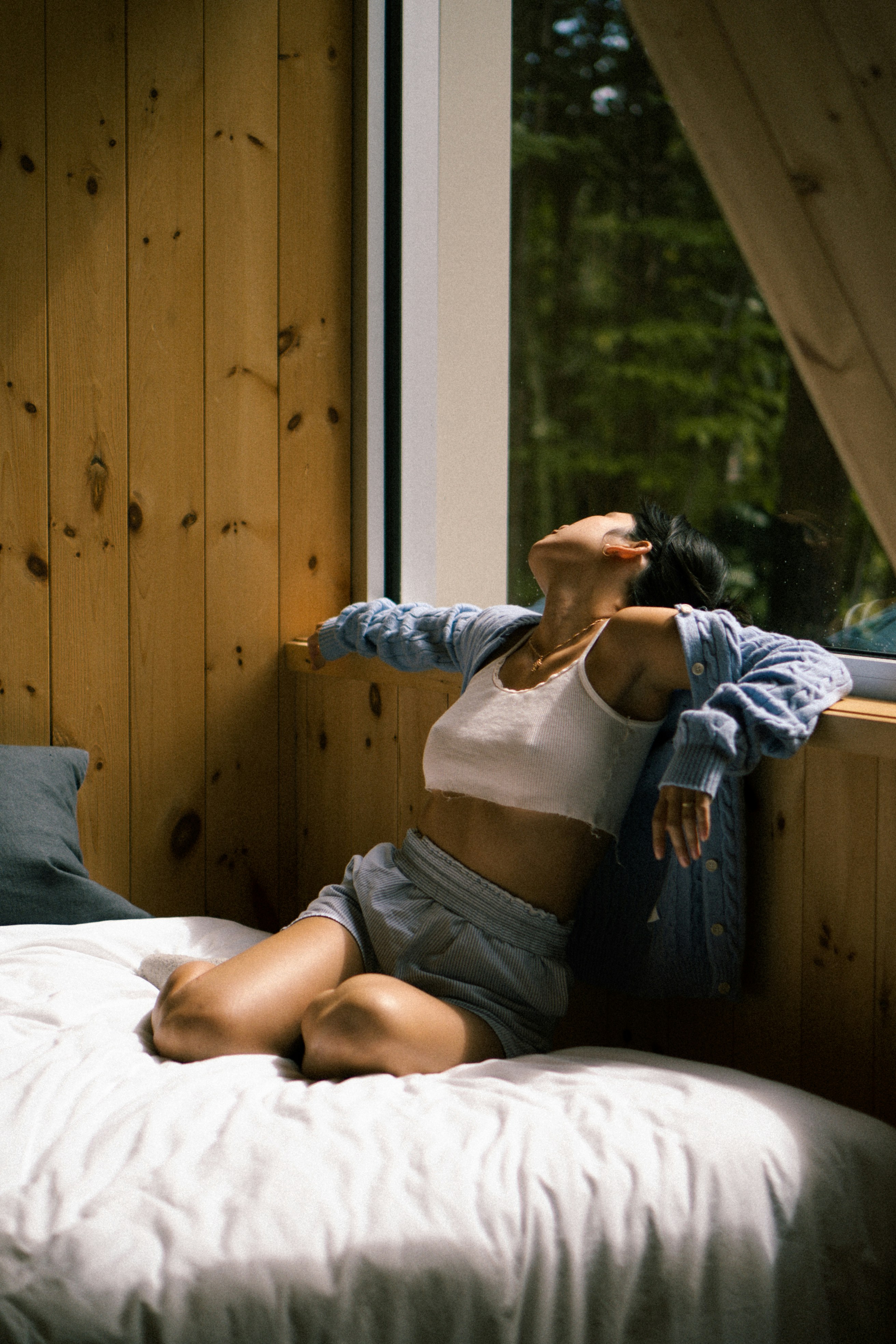 Portrait of a freckled woman with closed eyes in sunlight