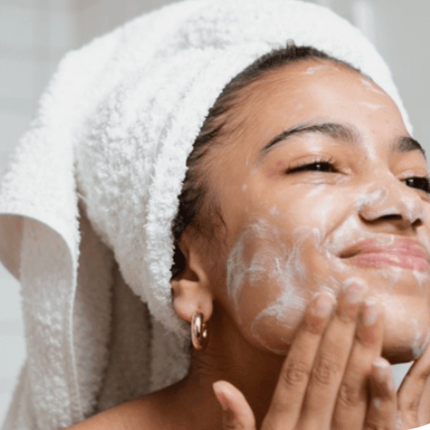A woman applying a facial mask