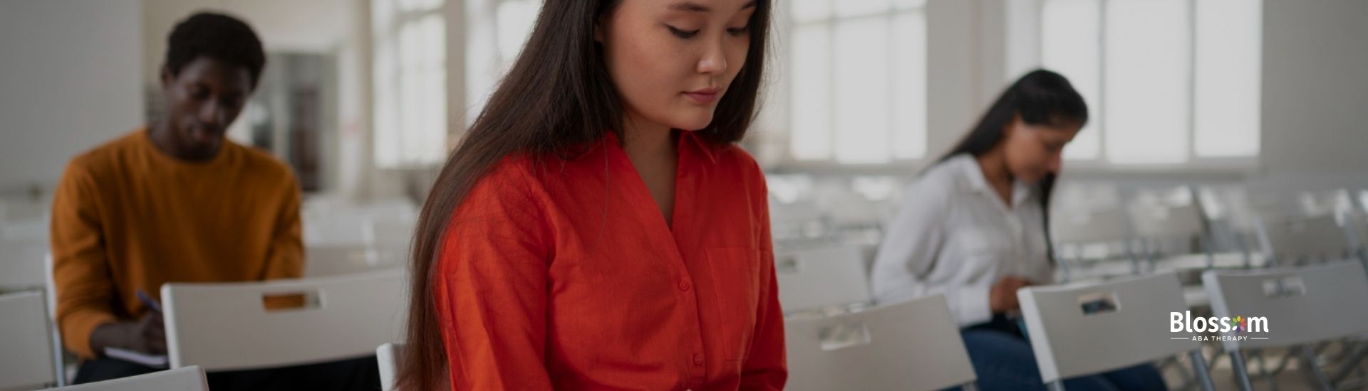 Student taking notes in a classroom setting.