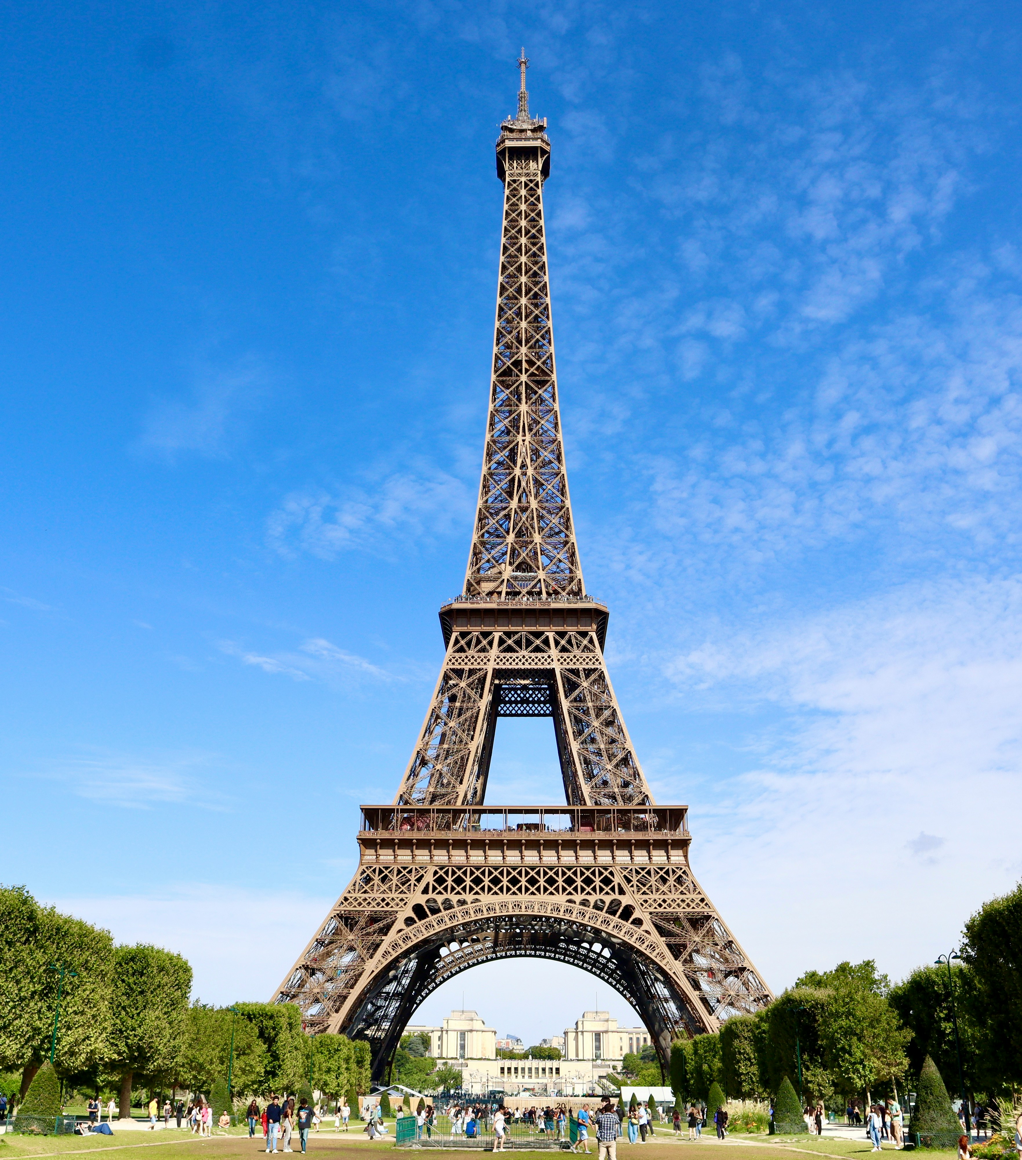 The eiffel tower stands tall against a clear blue sky.