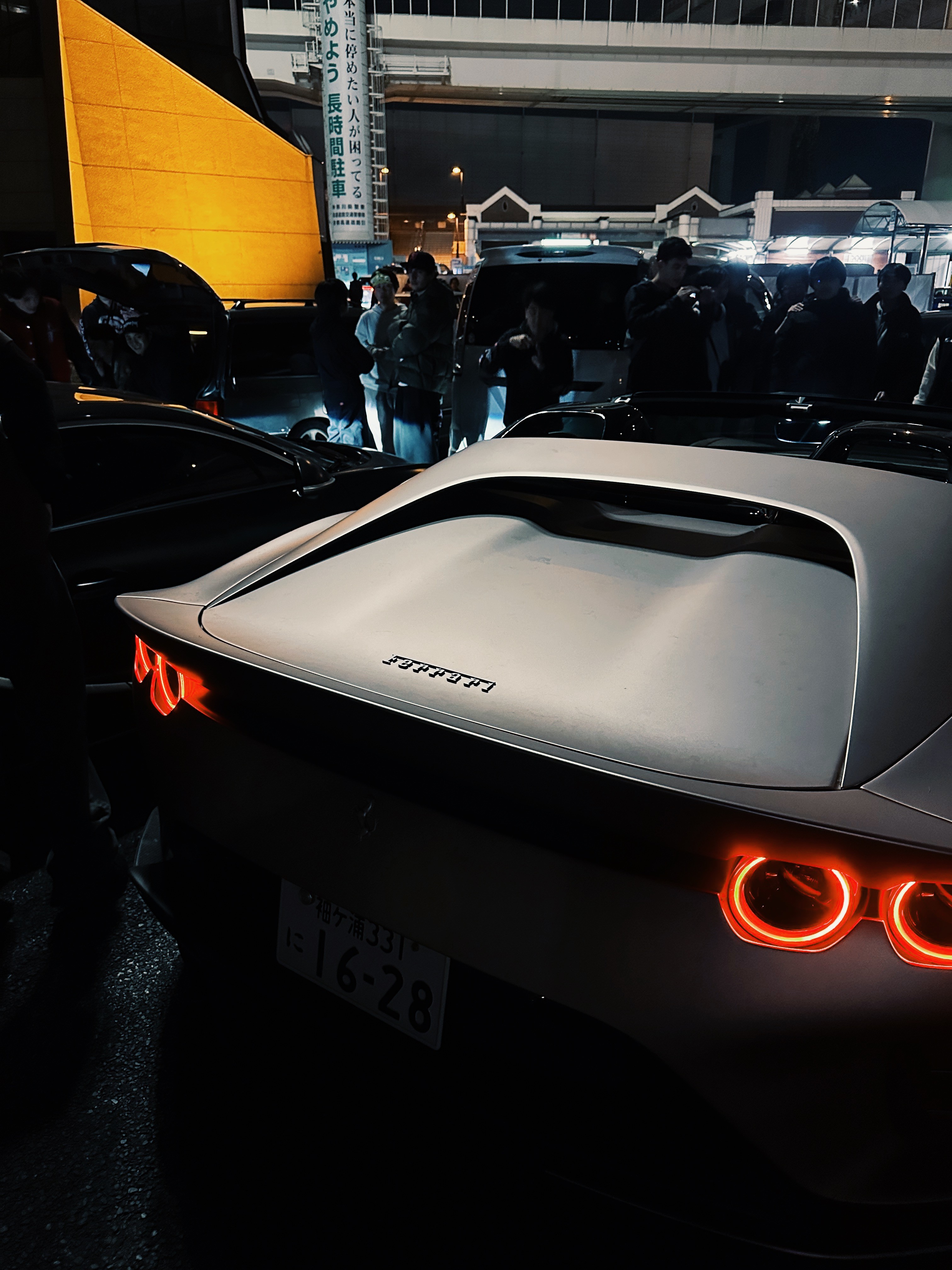 Several glowing blue jellyfish swim in dark water.