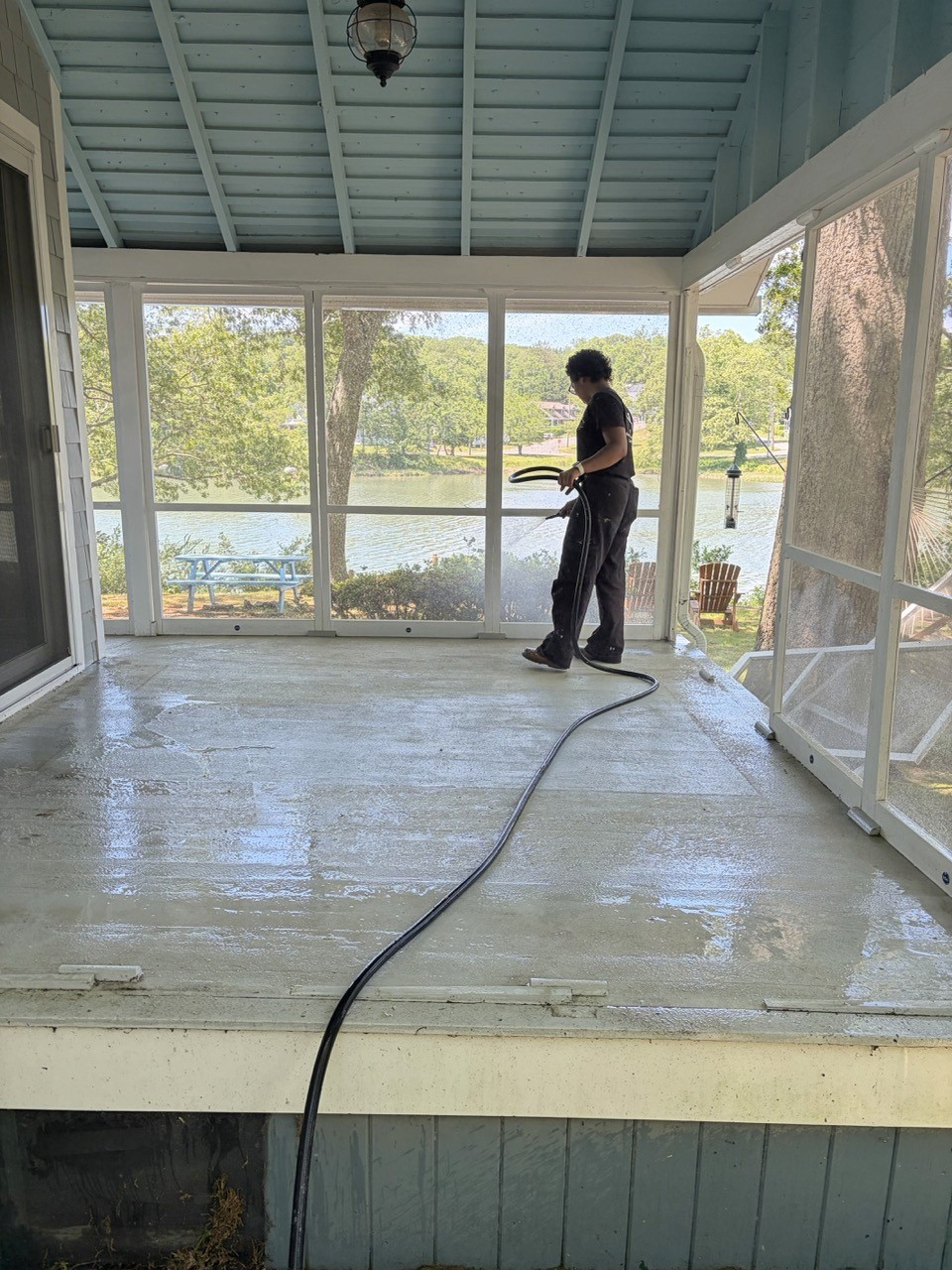 Cary Home Improvement crew member powerwashing an interior floor