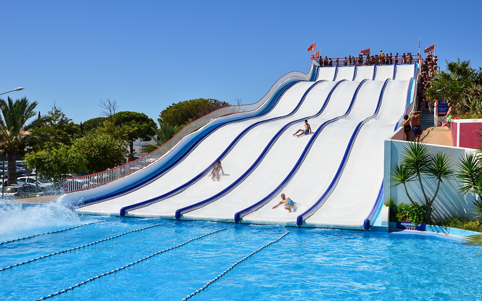 Visitors enjoying water slides at Aquashow Park, Portugal.