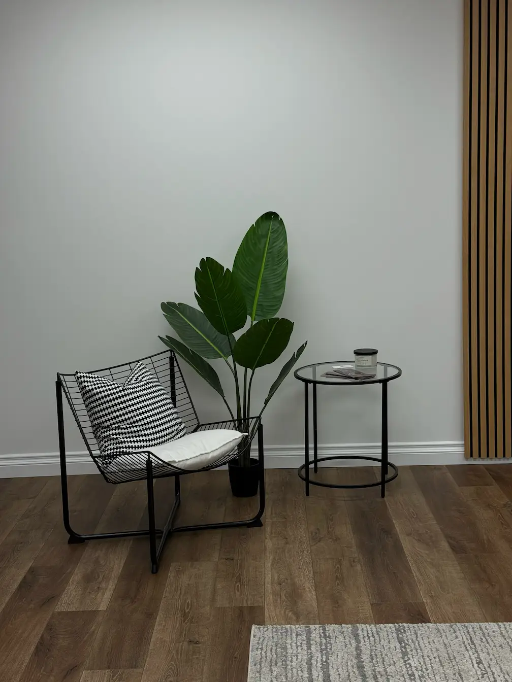 Open coworking area with rows of styling stations and wood flooring