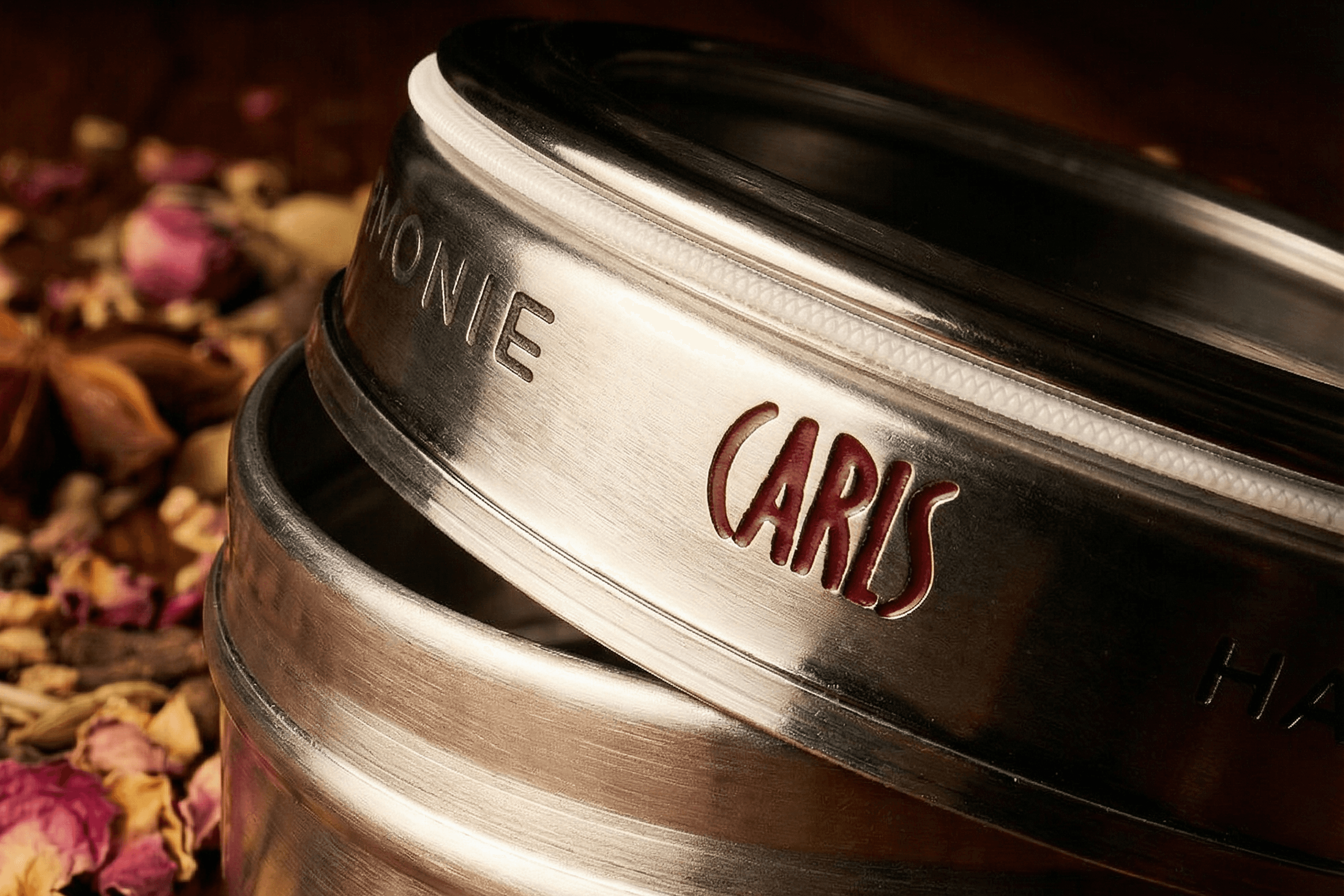 Metal tin with "CARLS" embossed on lid.