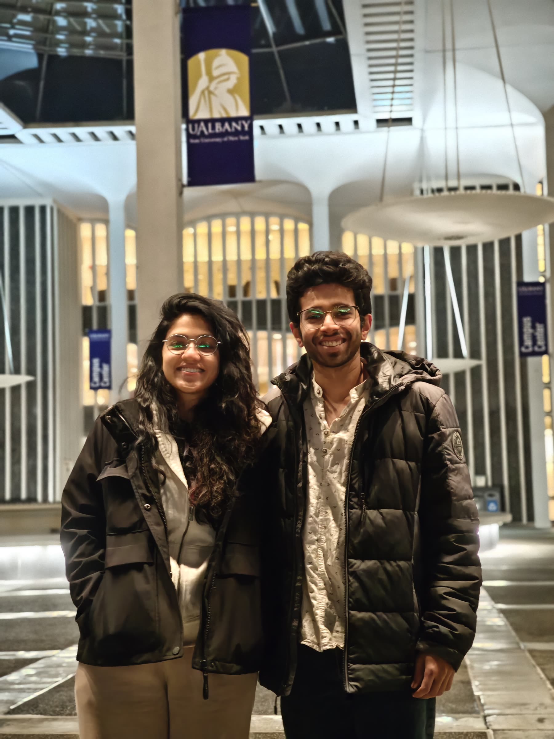Two friends standing outside at night