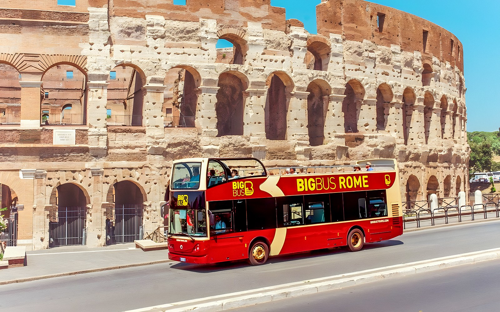 Big Bus tour near the Colosseum in Rome, Italy, offering hop-on hop-off sightseeing.