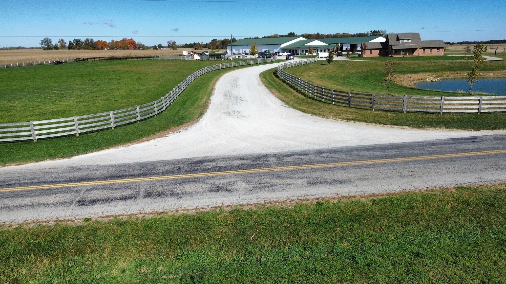 Modern bathroom featuring wooden cabinetry, a bathtub, a sleek sink, and natural light from a window.