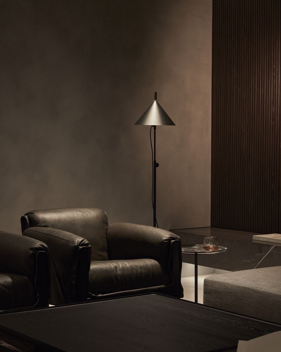Warm wood kitchen with open shelves, spice jars, countertop decor, and a bowl of fruit.
