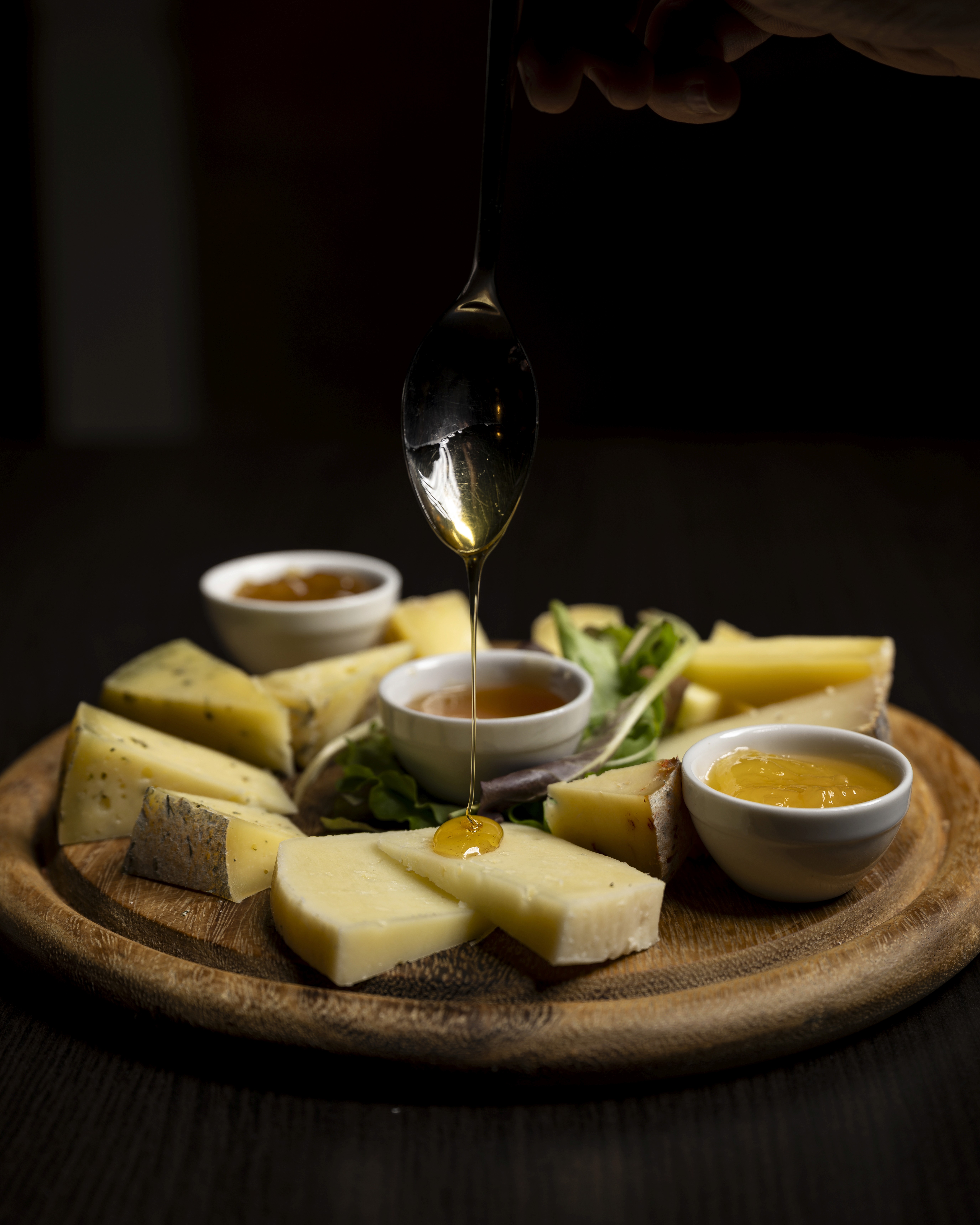 Restaurant bar with guests seated at tables and bartenders at work.