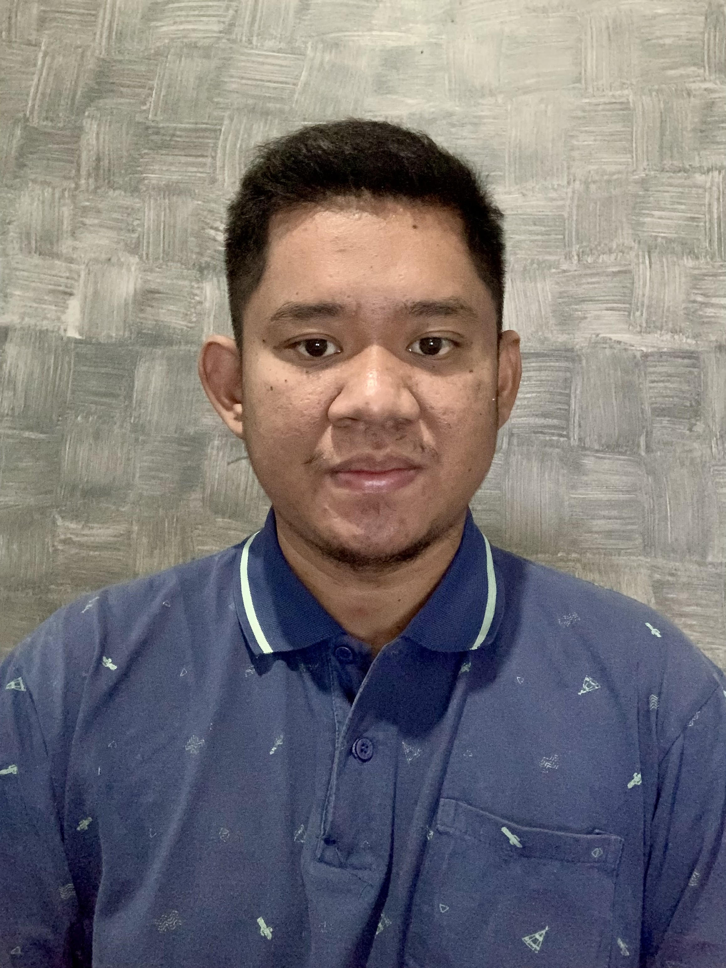 a man standing in front of a purple wall