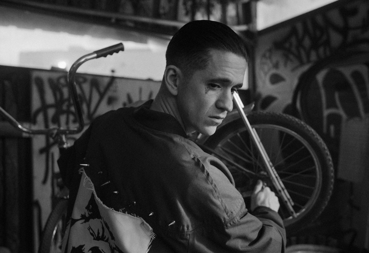 Character study from the feature film L'Ouragan F.Y.T., punk styling against a graffiti-covered garage backdrop
