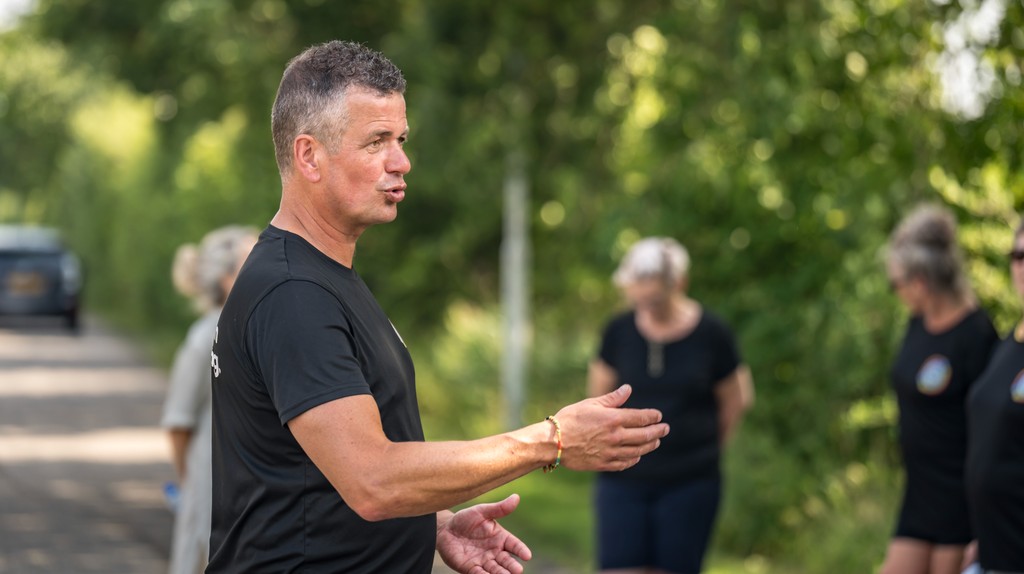 Snowboarder enjoys a downhill run on a sunny day.