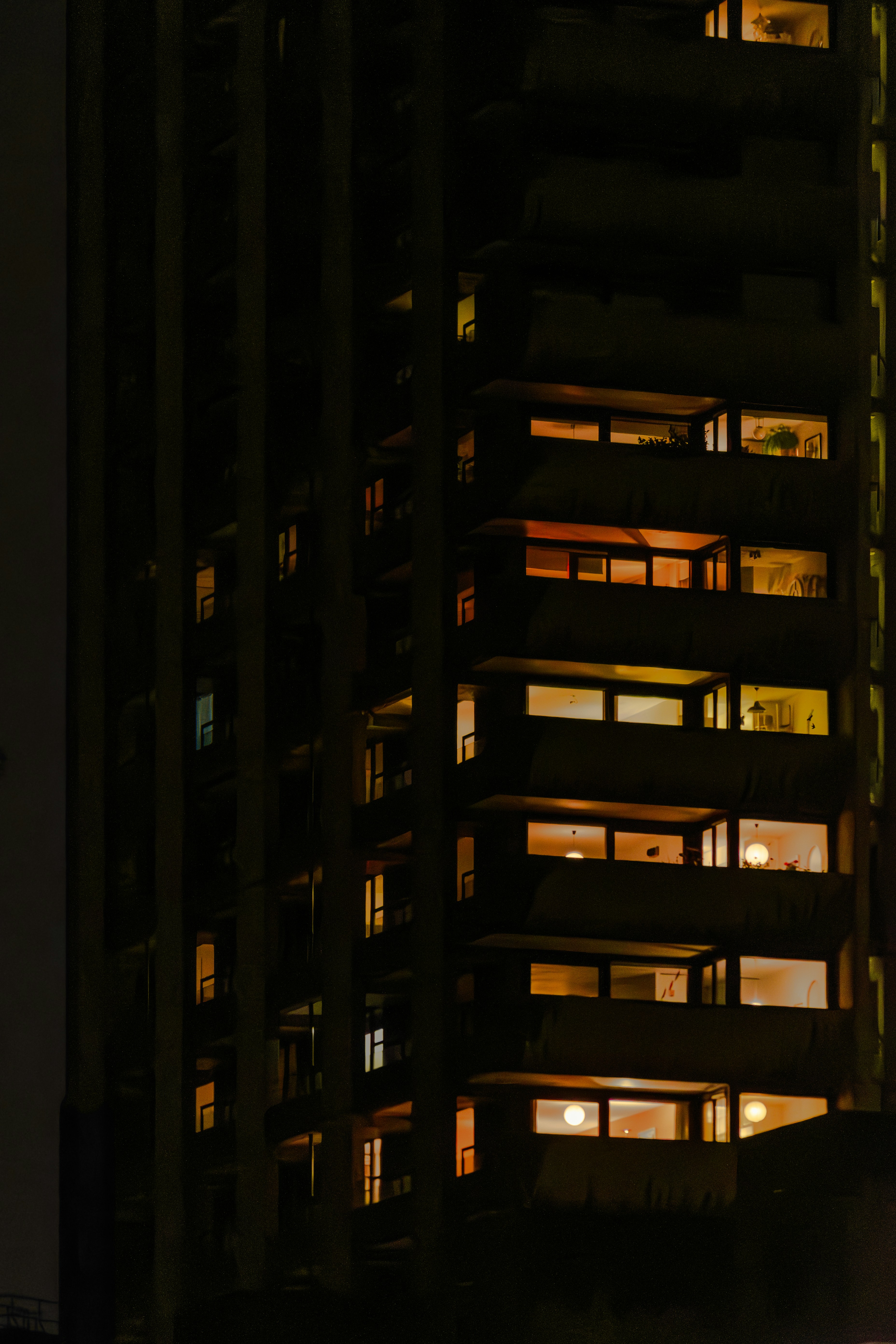 Apartment building windows lit up at night