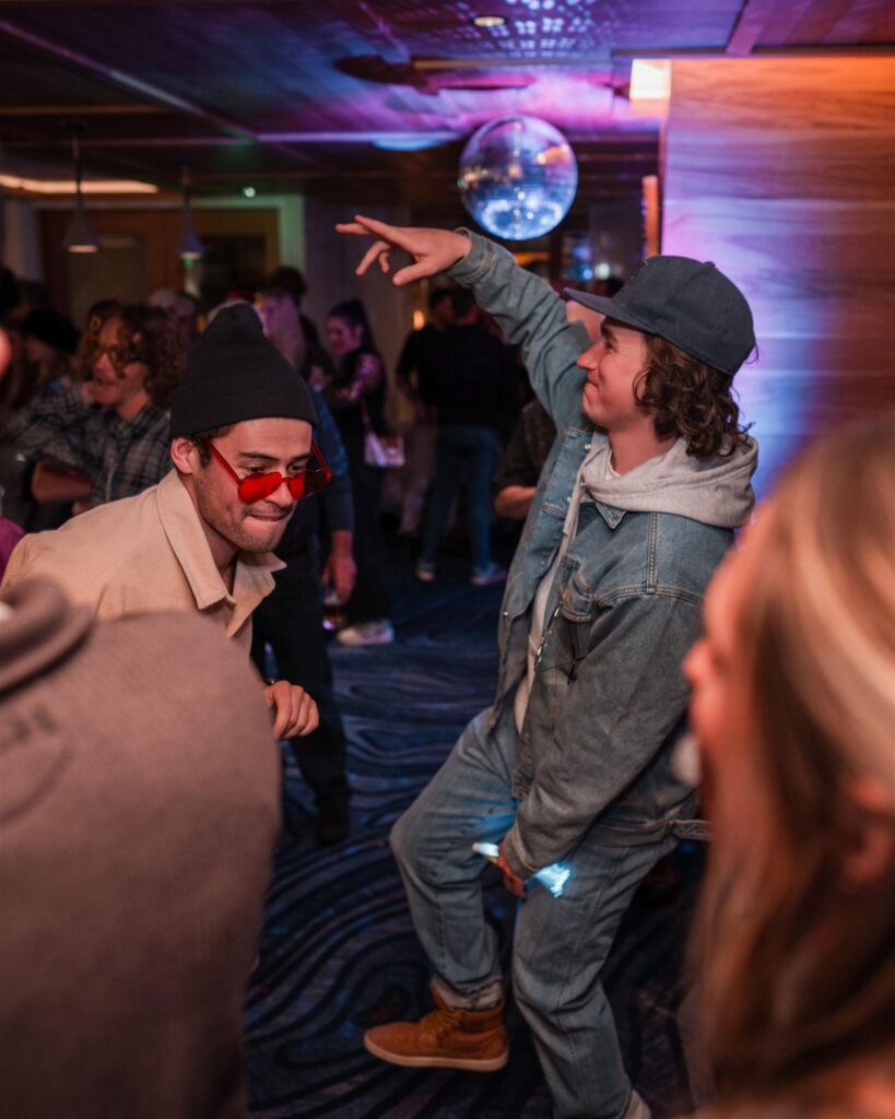 Two guests dancing together at an indoor event