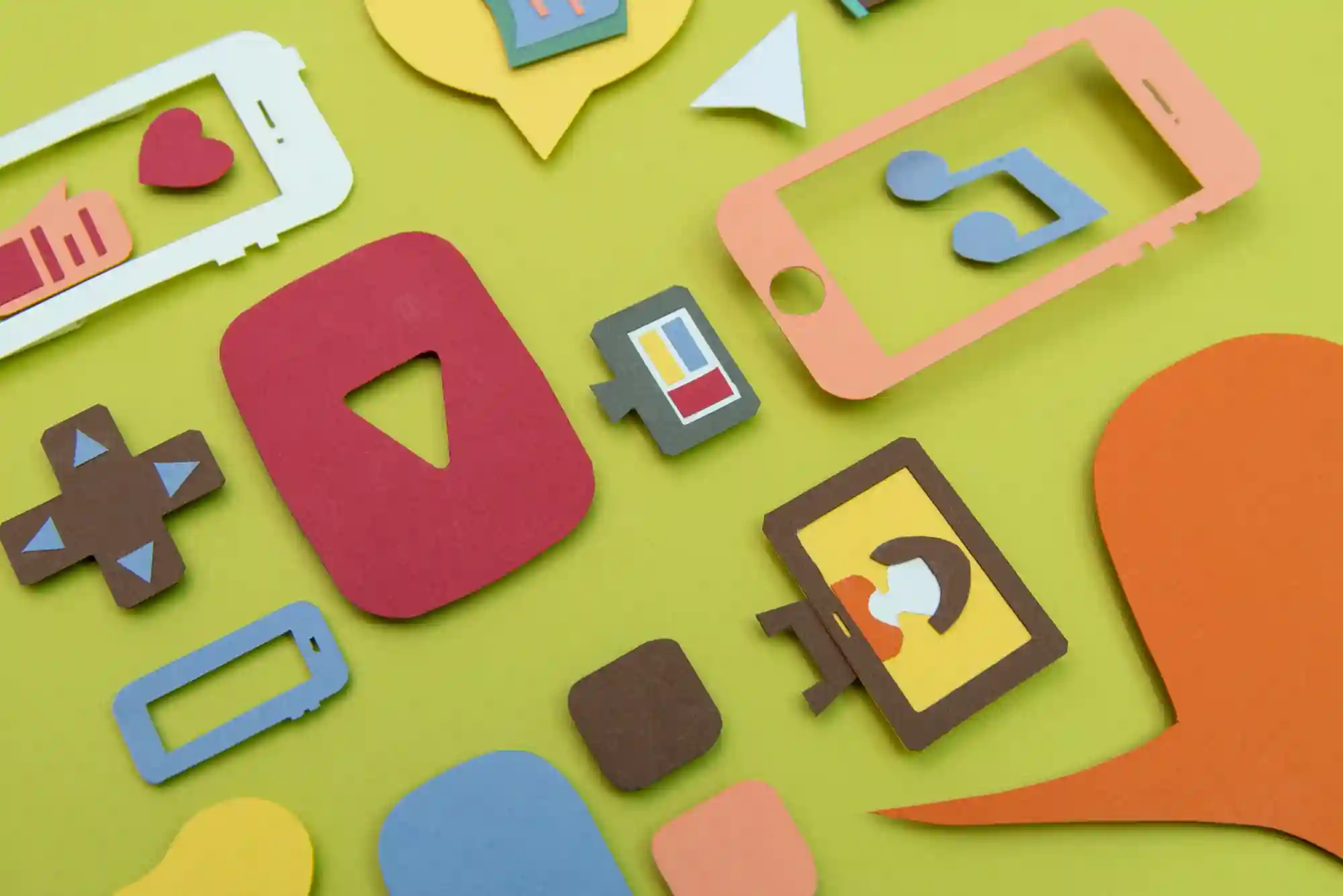  Paper cutouts depicting various social media, entertainment, and digital communication app icons on a vibrant green background.