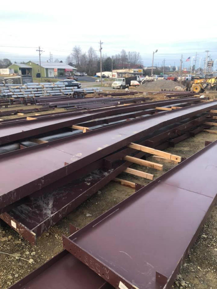 Stacks of metal beams staged on a construction site