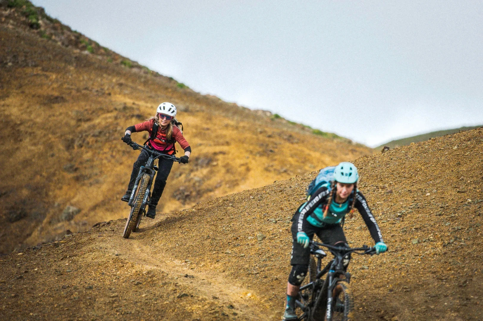 Two women ride towards camera