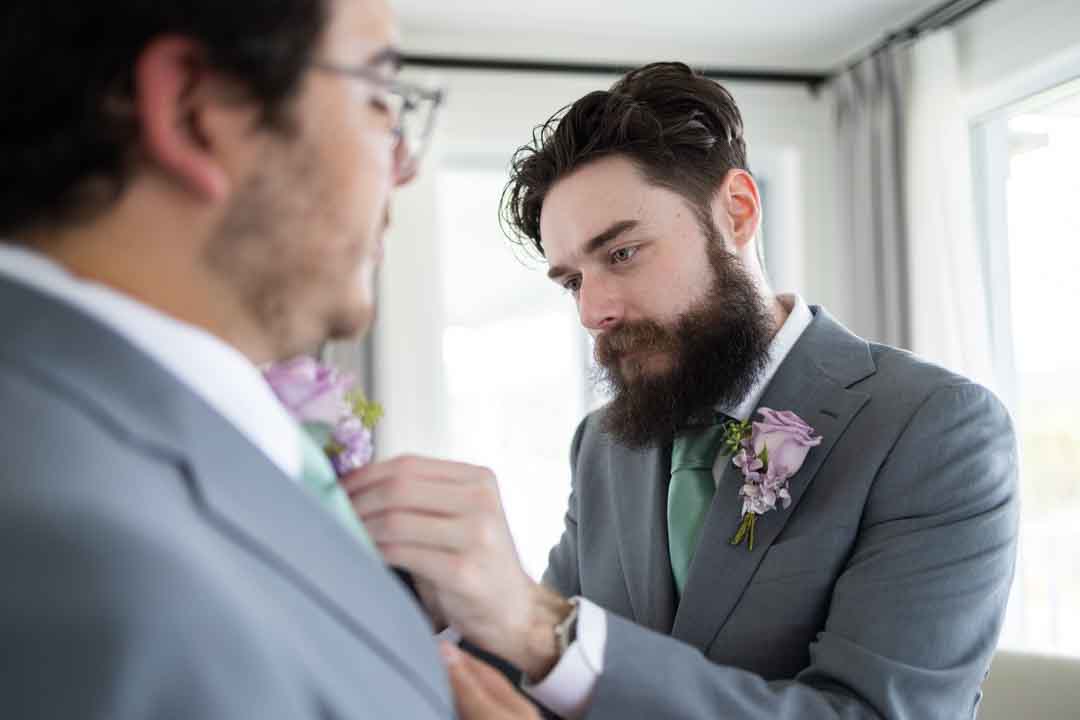 Groomsmen adjusting boutonnière