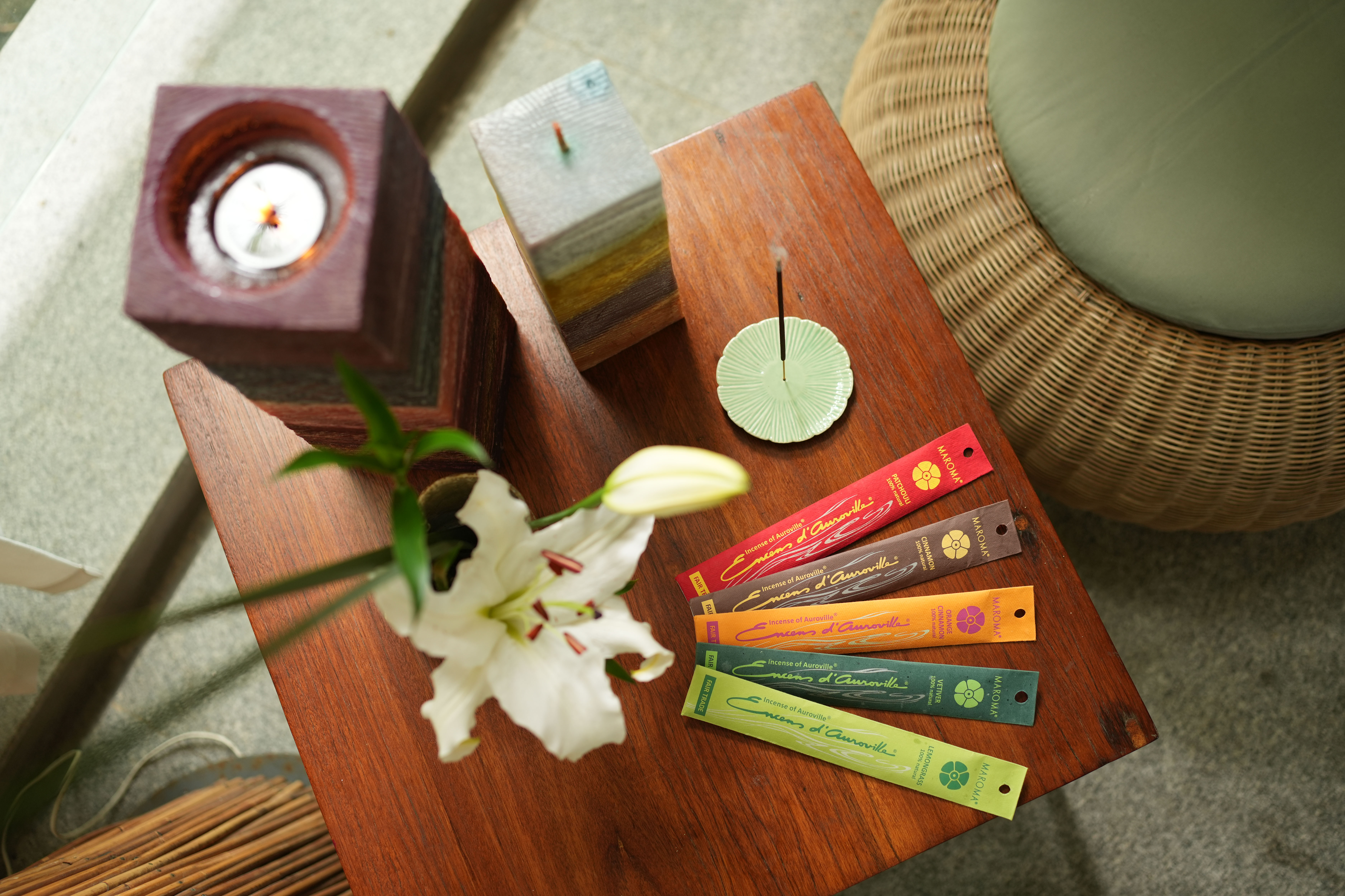 A cozy scene with warm sunlight casting stripes, featuring a potted plant and soft towels on a window sill.