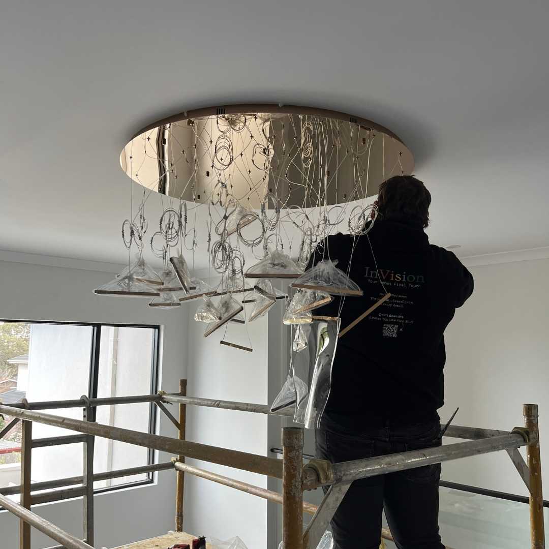 A young person with long, wavy hair sits in front of a plain background, looking directly at the camera.