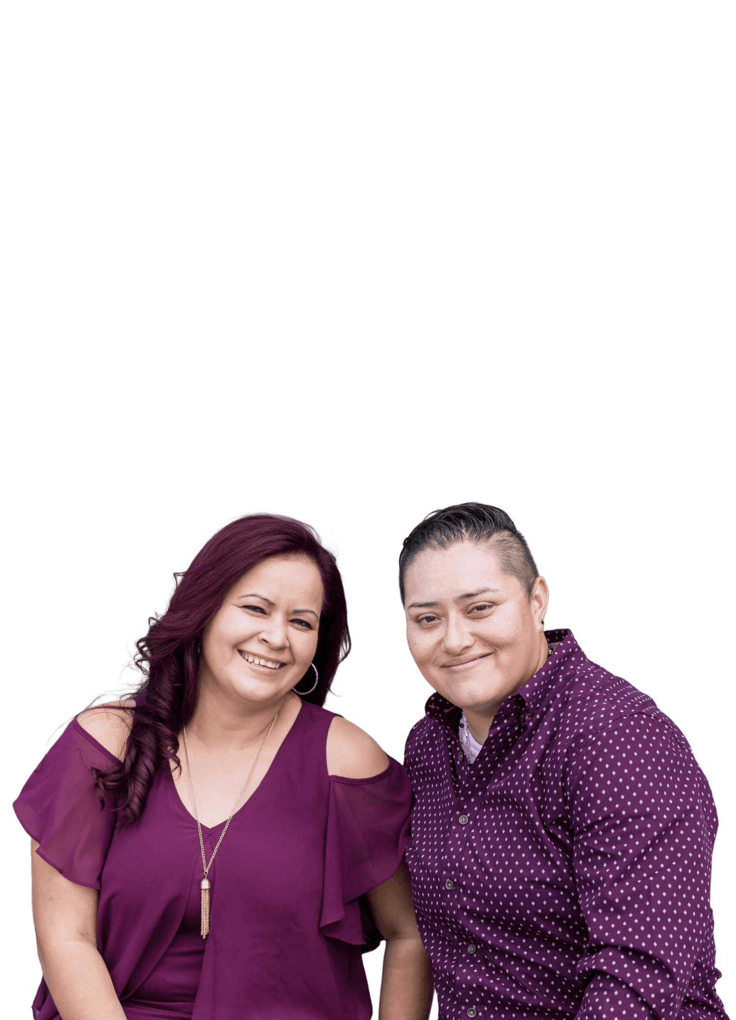 Two people wearing matching purple outfits pose together happily against a plain background, showcasing a sense of unity and fashion coordination.