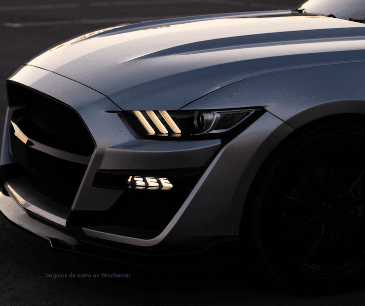 La parte de alfrente del mustang con las luces encendidas