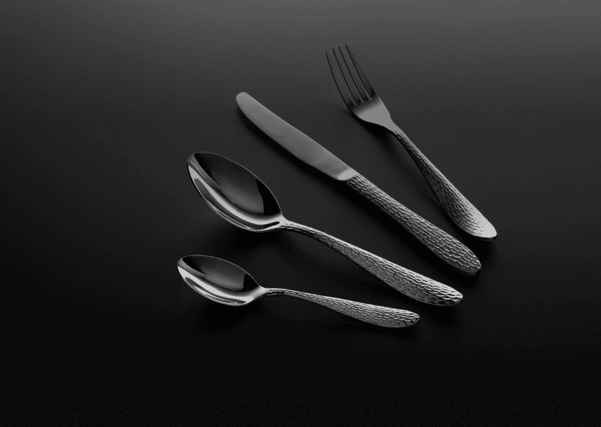 A serene outdoor lounge area with two chairs surrounded by lush greenery and natural light streaming in.