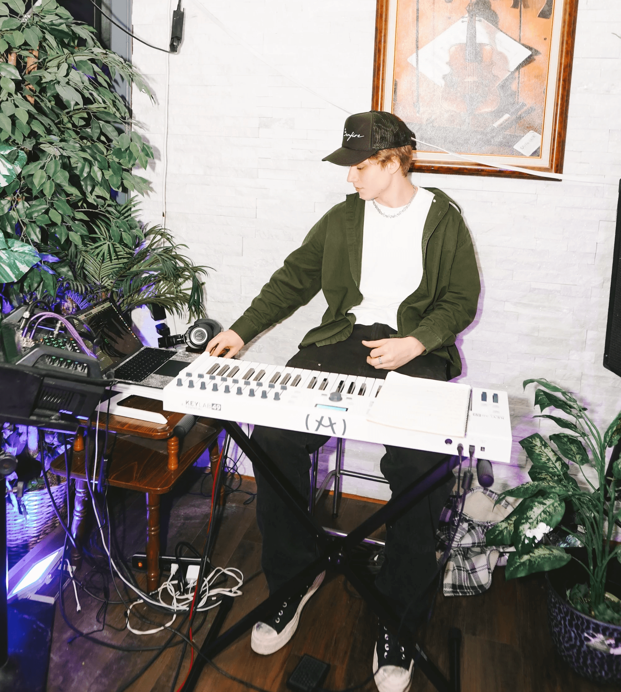 A close-up of a person wearing green-tinted glasses, with a serious expression and smooth skin.