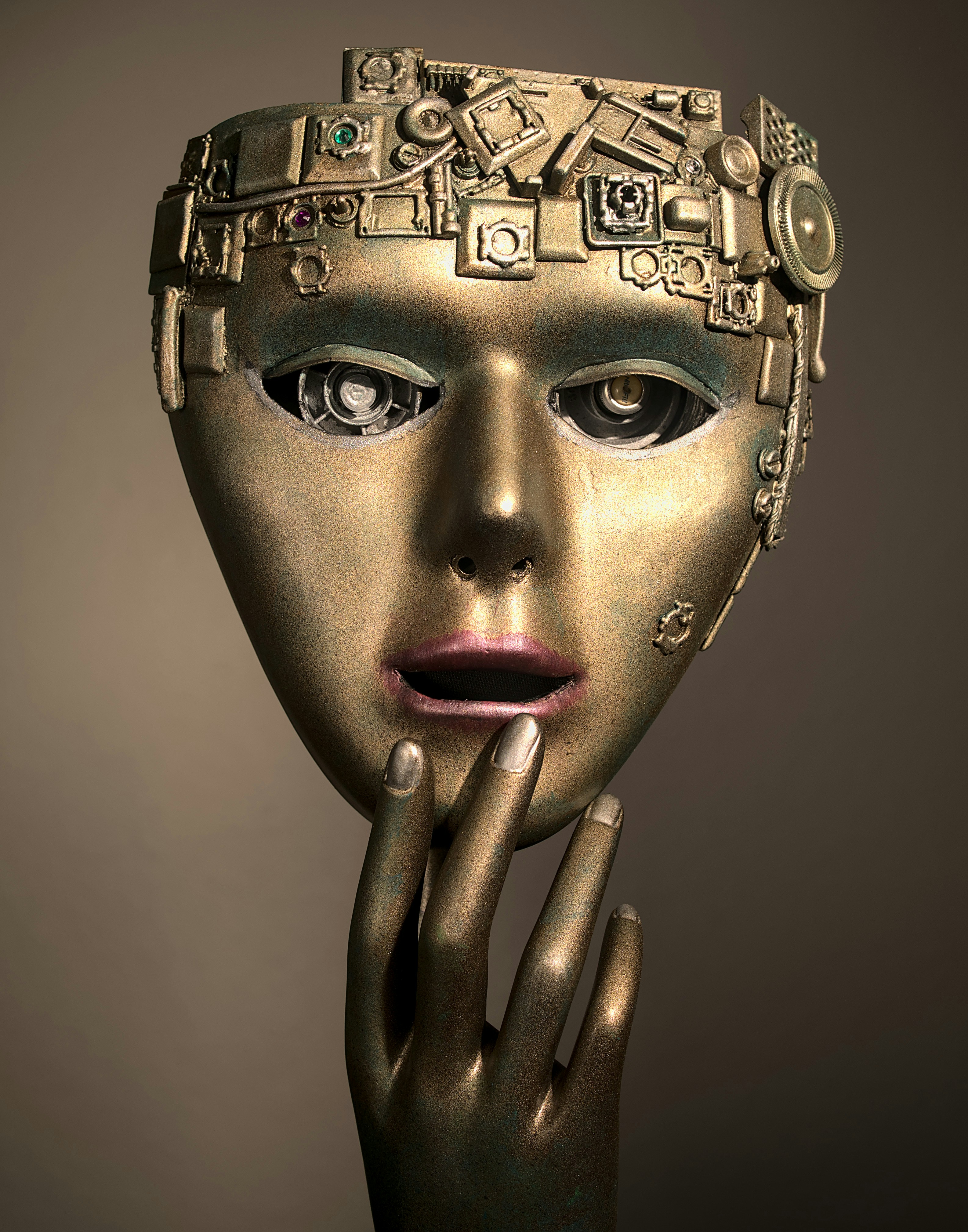 a woman's face with a gold mask on her head