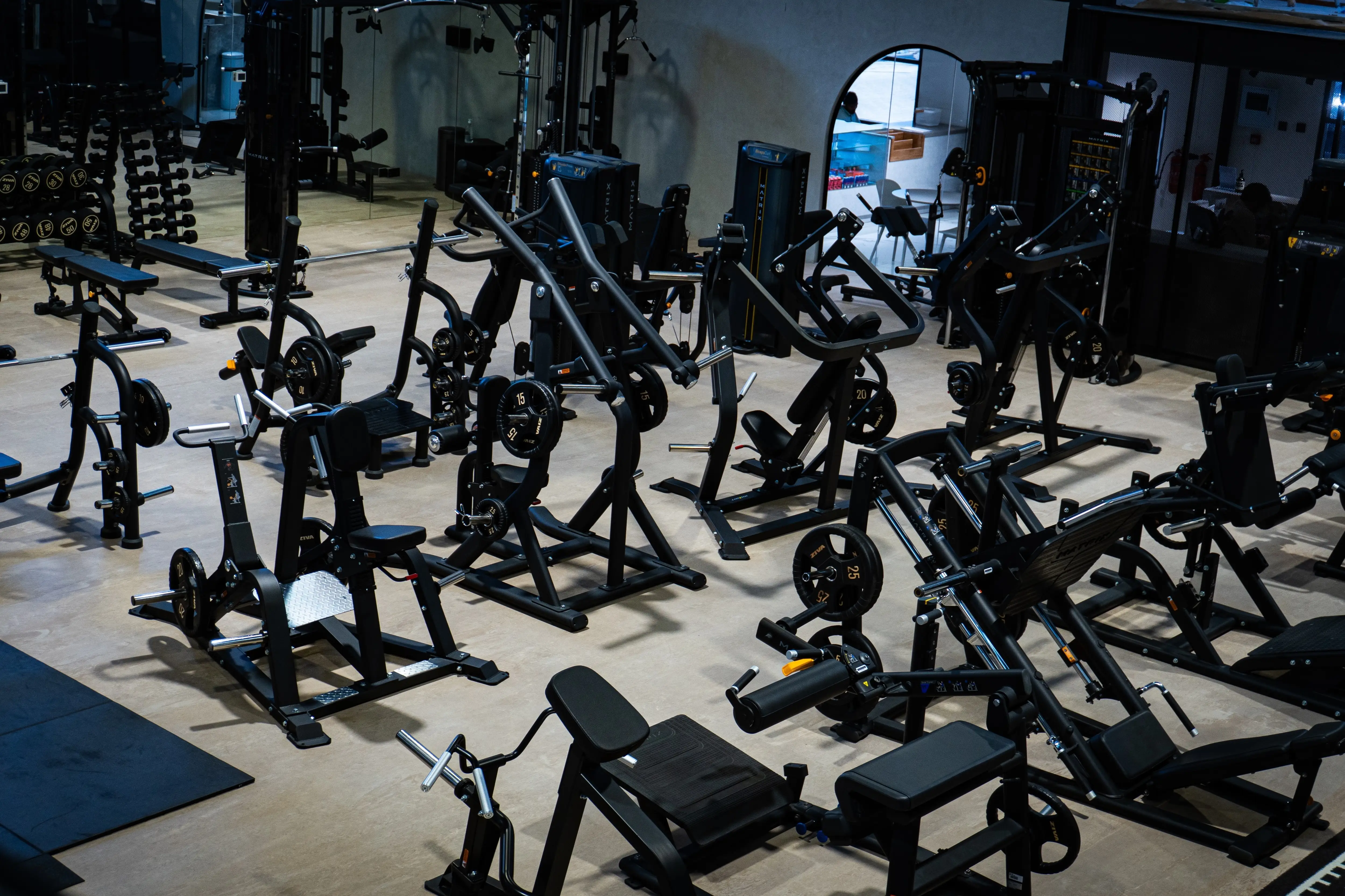 A variety of weight machines and workout equipment in the strength zone.