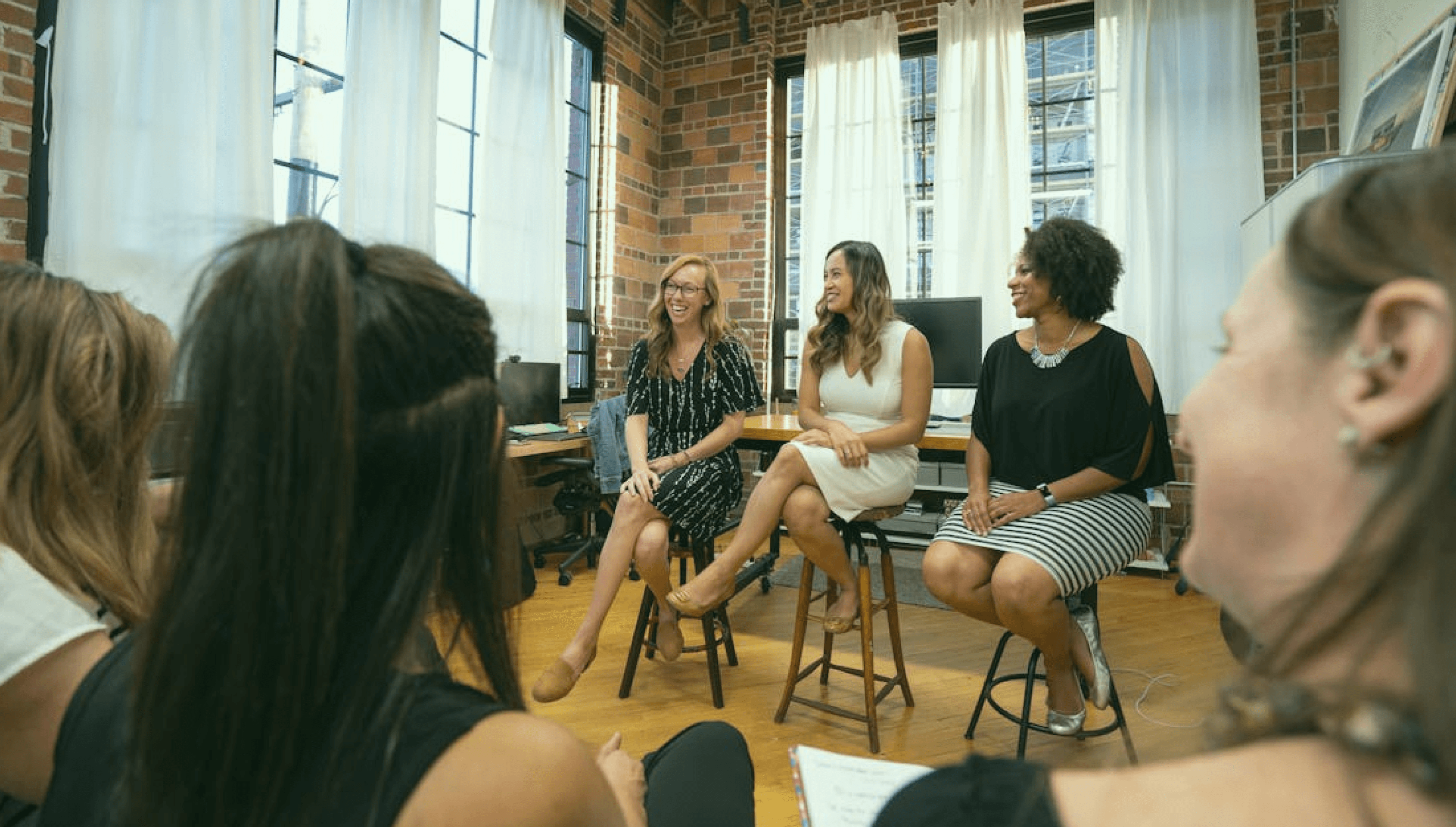 Women discussing about different needs in a community setting.