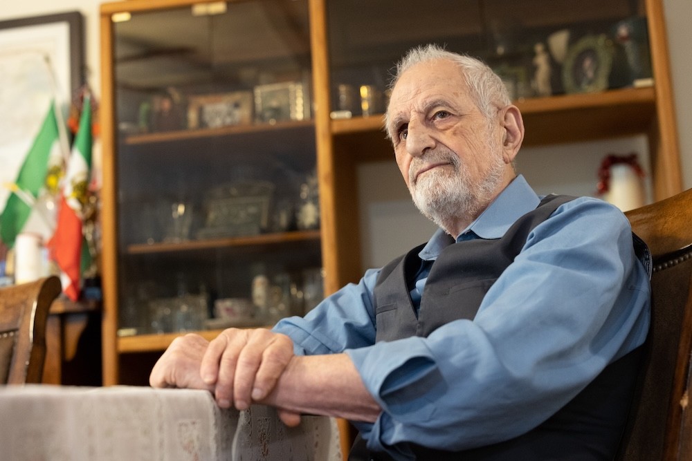 Bubjan with book and speaking to camera