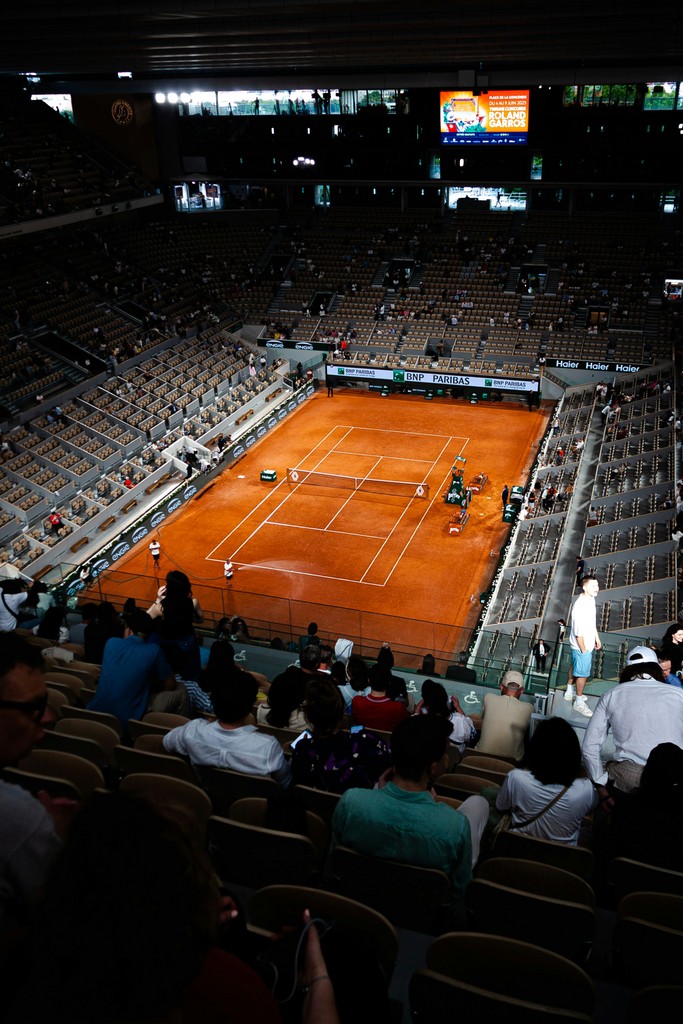 Tennis match in an expansive arena.