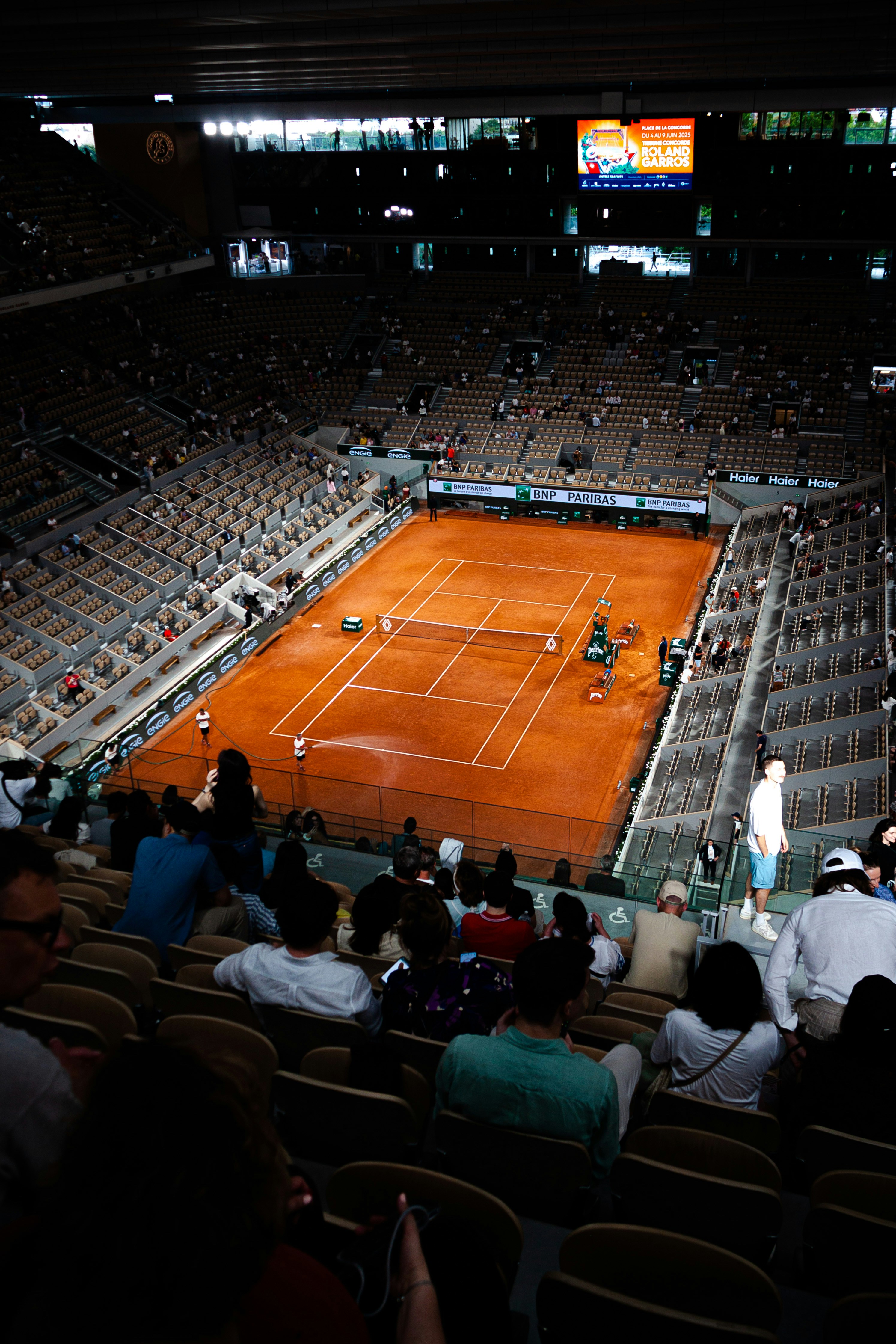 Tennis match in an expansive arena.