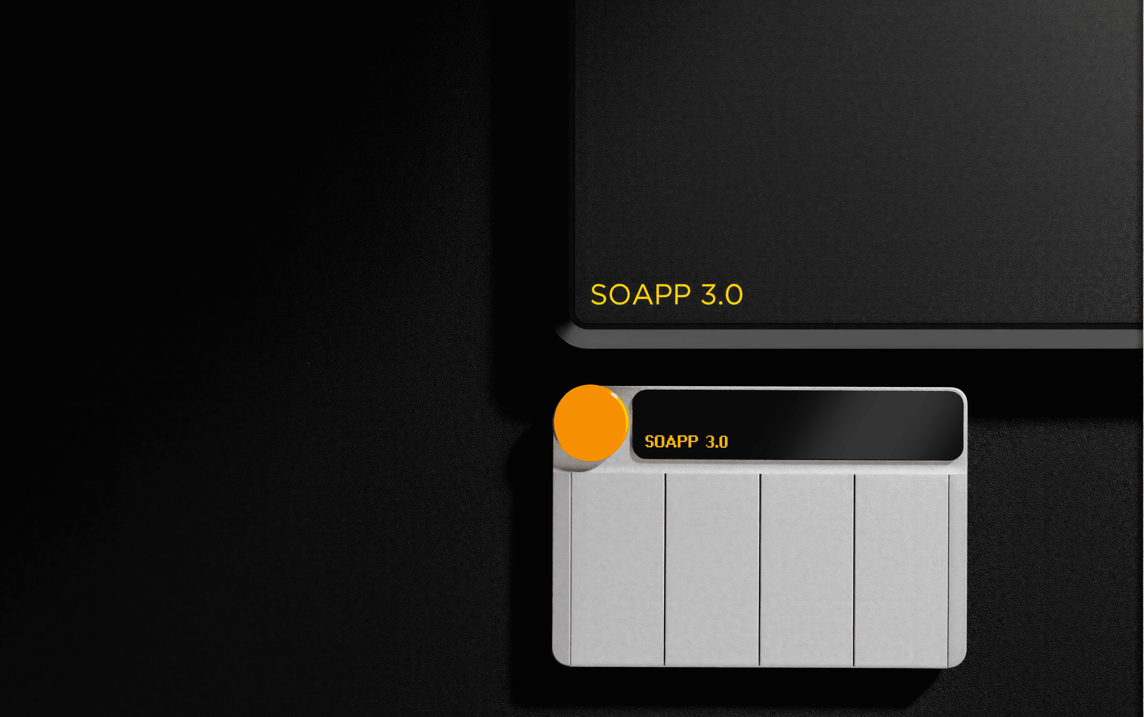 Close up shot of the Riff MIDI Link control device and its connection unit, both featuring the text “SOAPP 3.0”, set against a black background, with a matte white finish on the small device and a dark matte plastic finish on the control station.