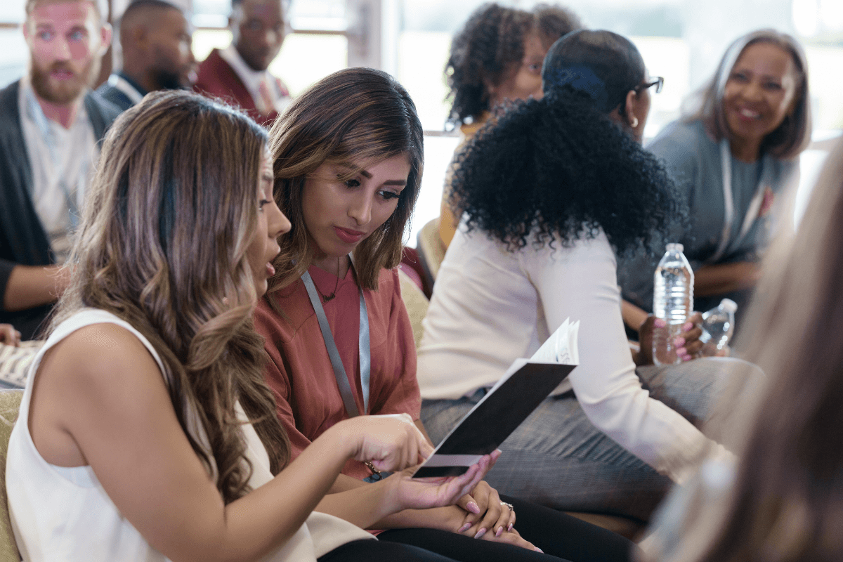 People sitting and talking in a busy room.