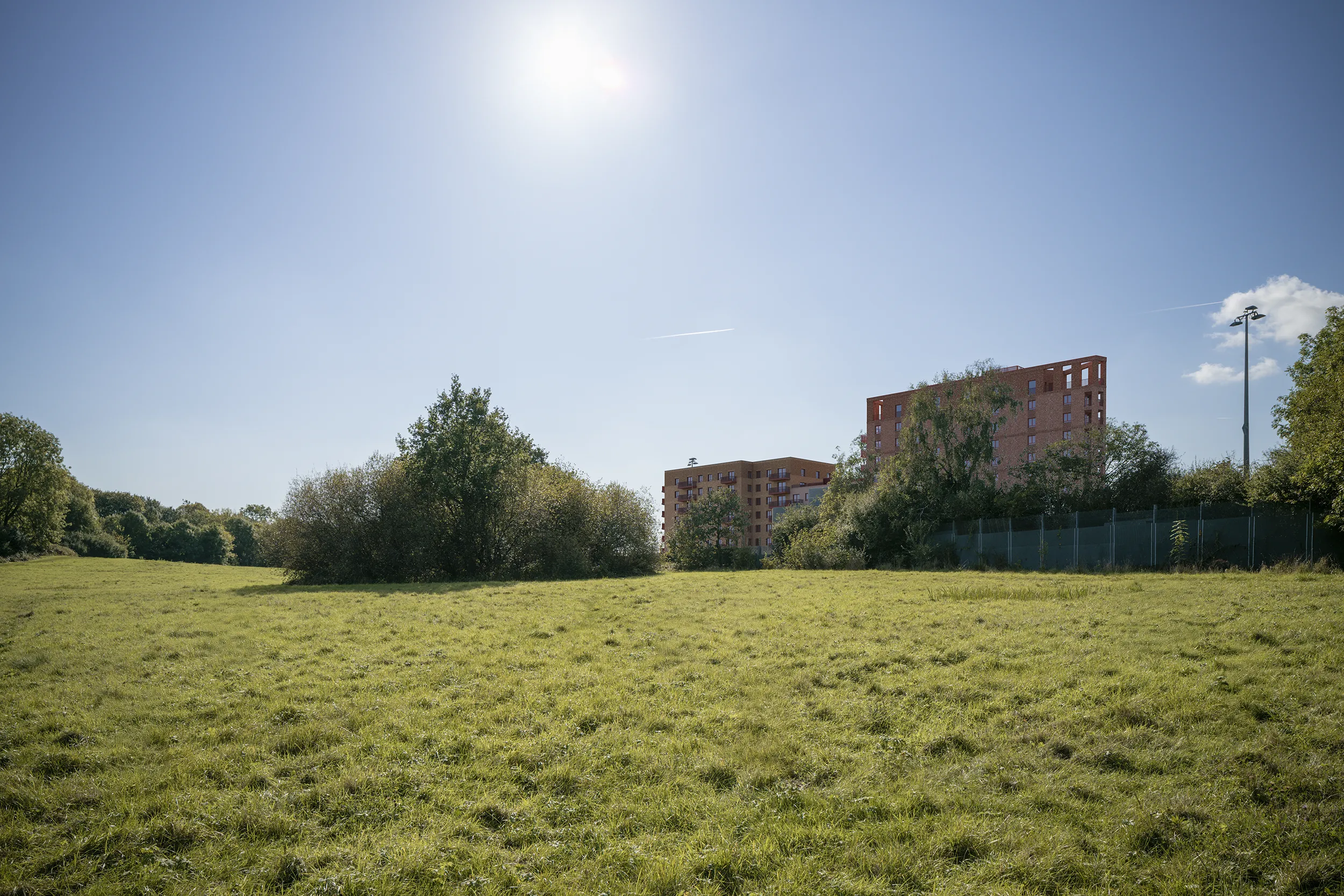 Type 4 AVR Level 3 verified view due south from the London Loop footpath, showing Buildings A and B behind Abrams House across the grassed open space beside the railway.