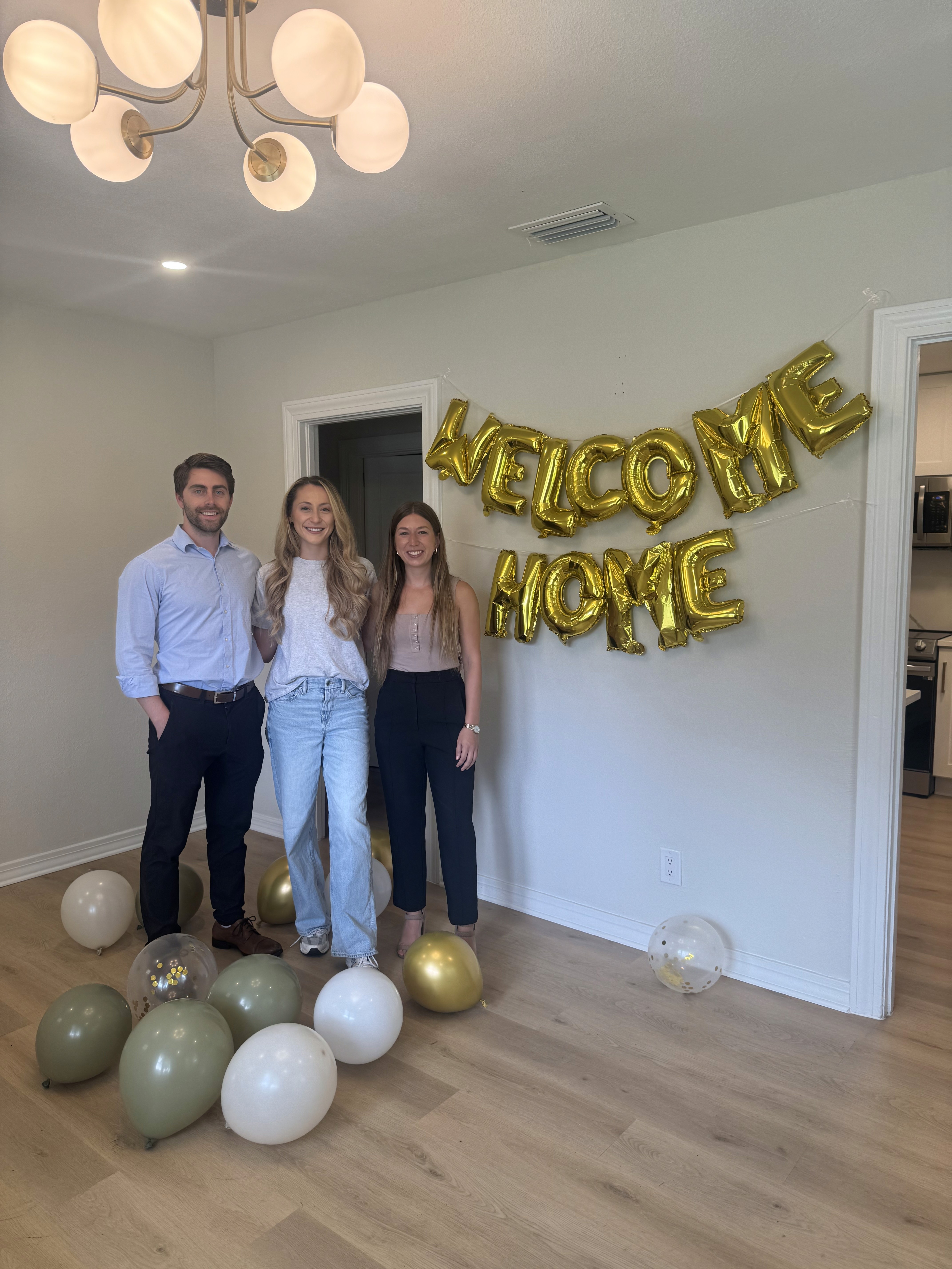 Julie Morris standing with clients inside newly purchased home in Tampa Bay