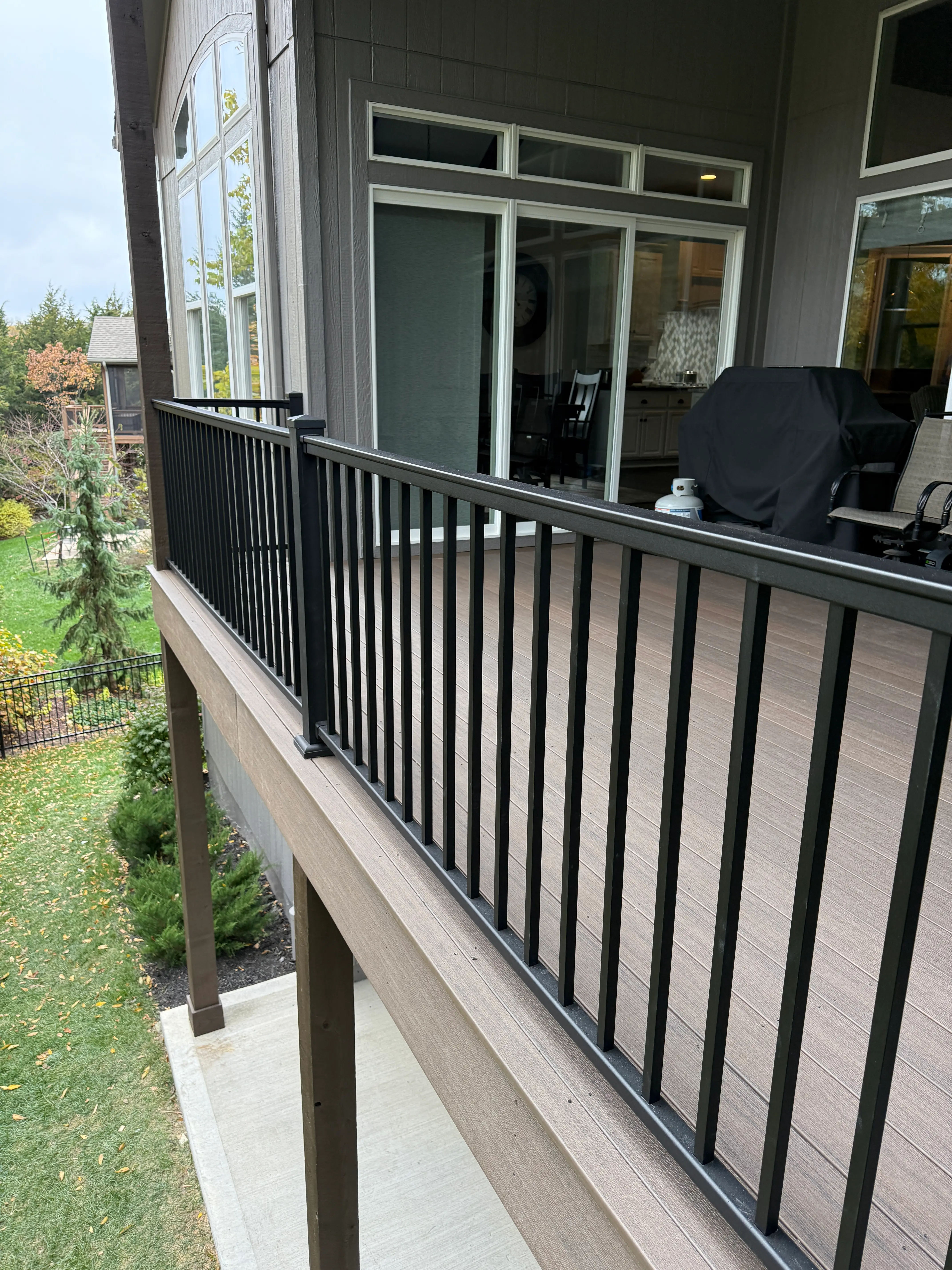 An image of newly installed black iron railings on a second level deck.
