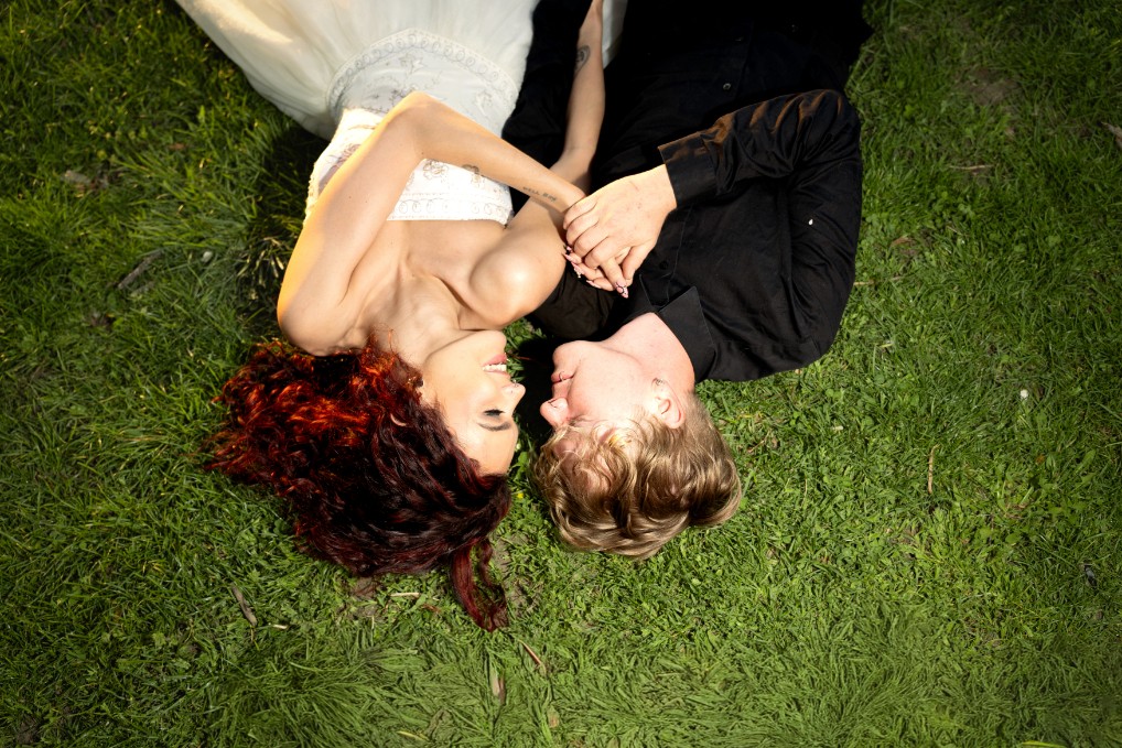 A couple in formal wedding attire embraces intimately in a vast.